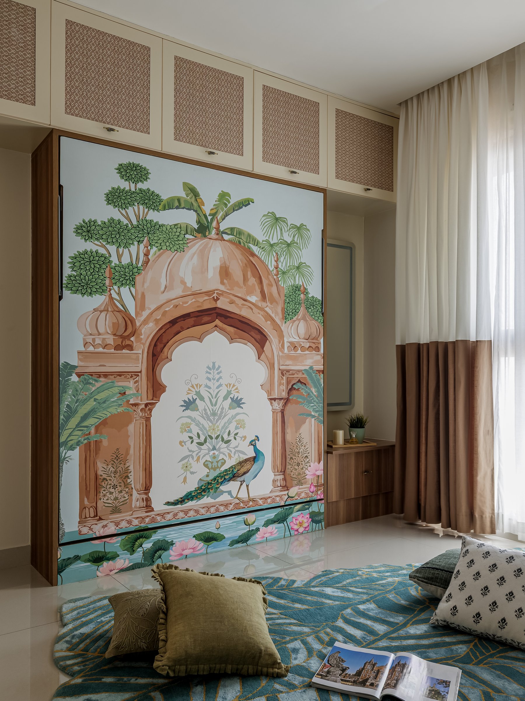 The guest bedroom, where the Invisible bed closes flush into a wall painted with a chhatri and peacock mural