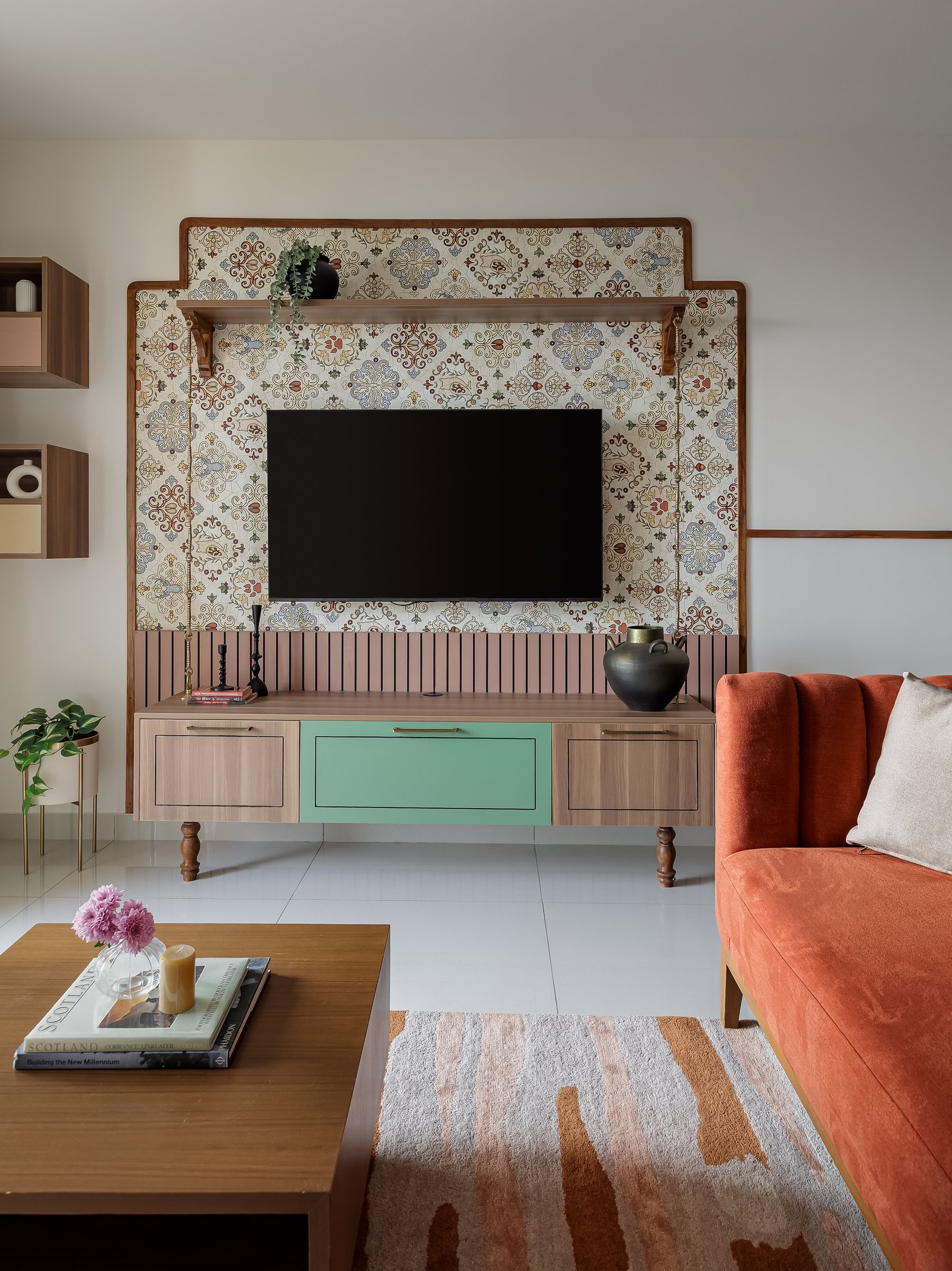 The media console, its turned legs and alternating drawer fronts introducing the home's recurring green