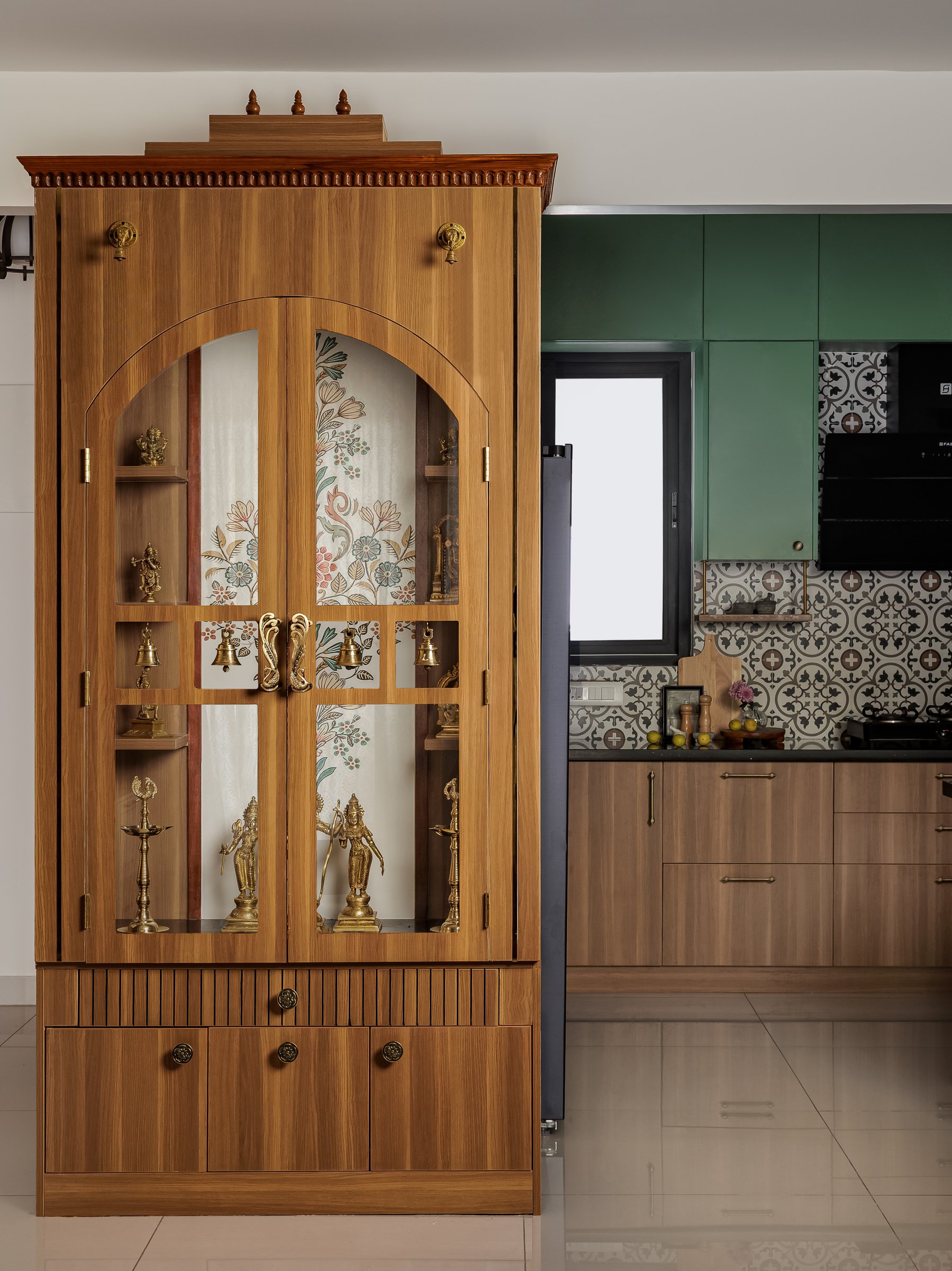 The Pooja unit closed, its temple-inspired crown and arched glass shutters given prominent placement