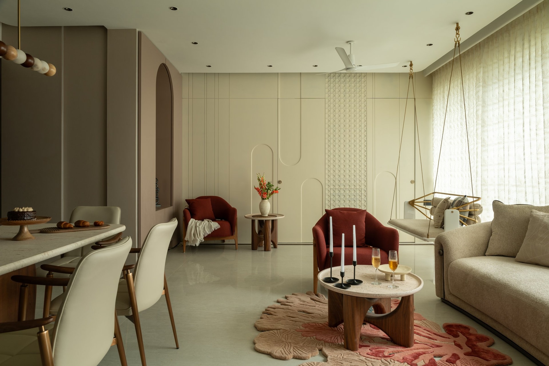 The panelled wall along the living room, where grooves conceal two bedroom doors and storage within a single continuous surface