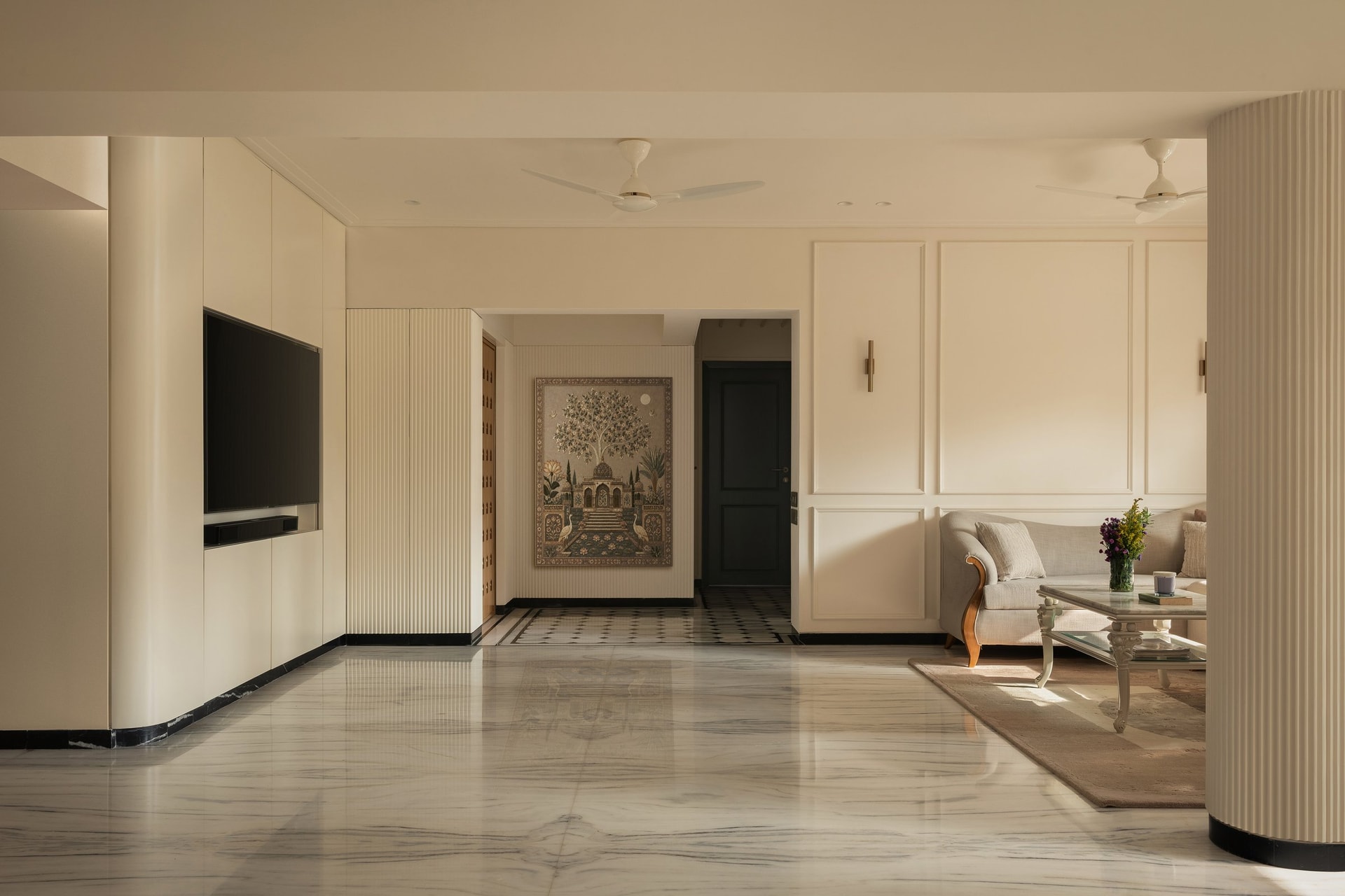 The living volume, where fluted columns and panelled walls establish the home's contemporary classic language