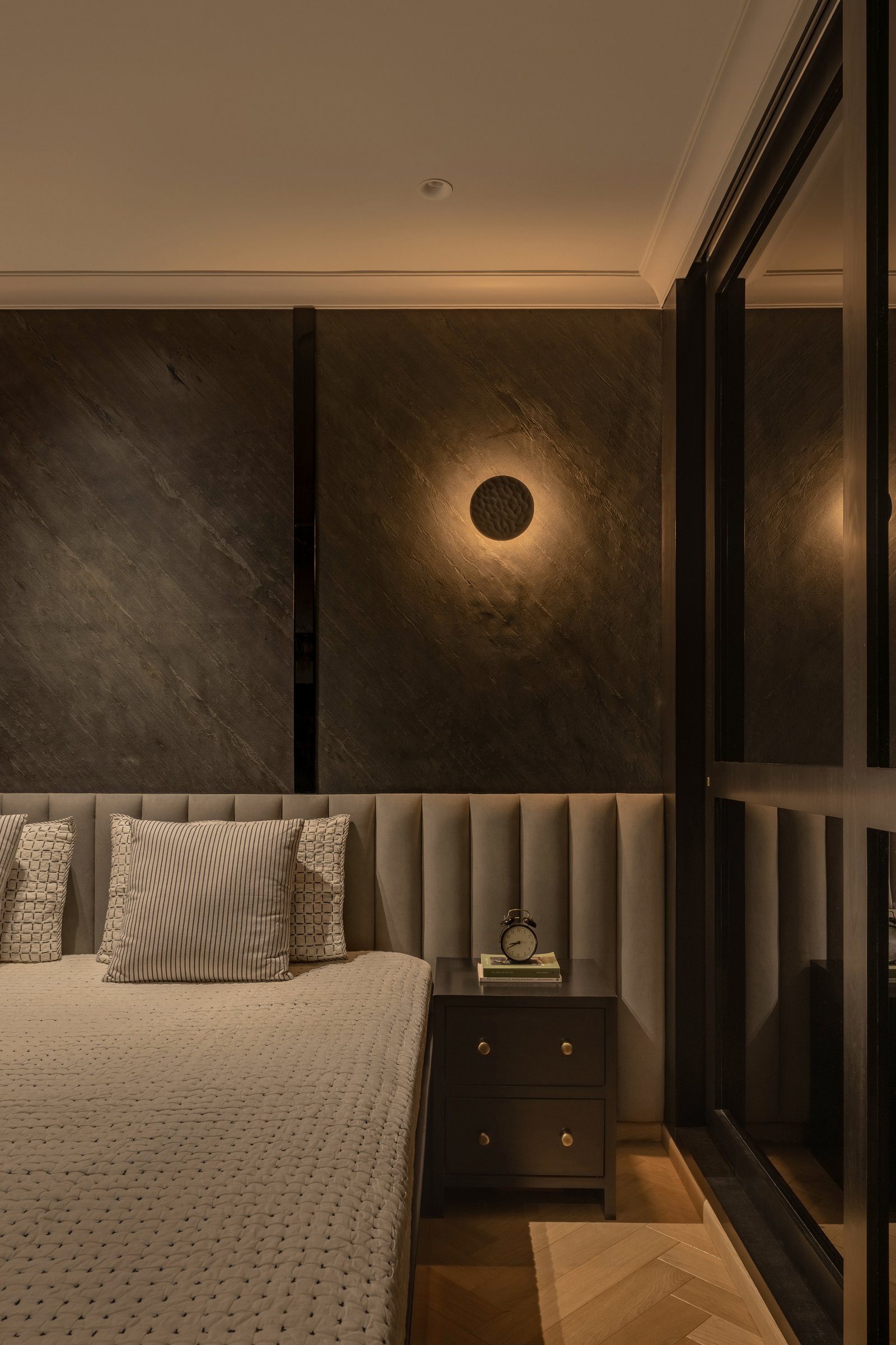 The son's bedroom takes the darkest register in the home, restrained rather than theatrical