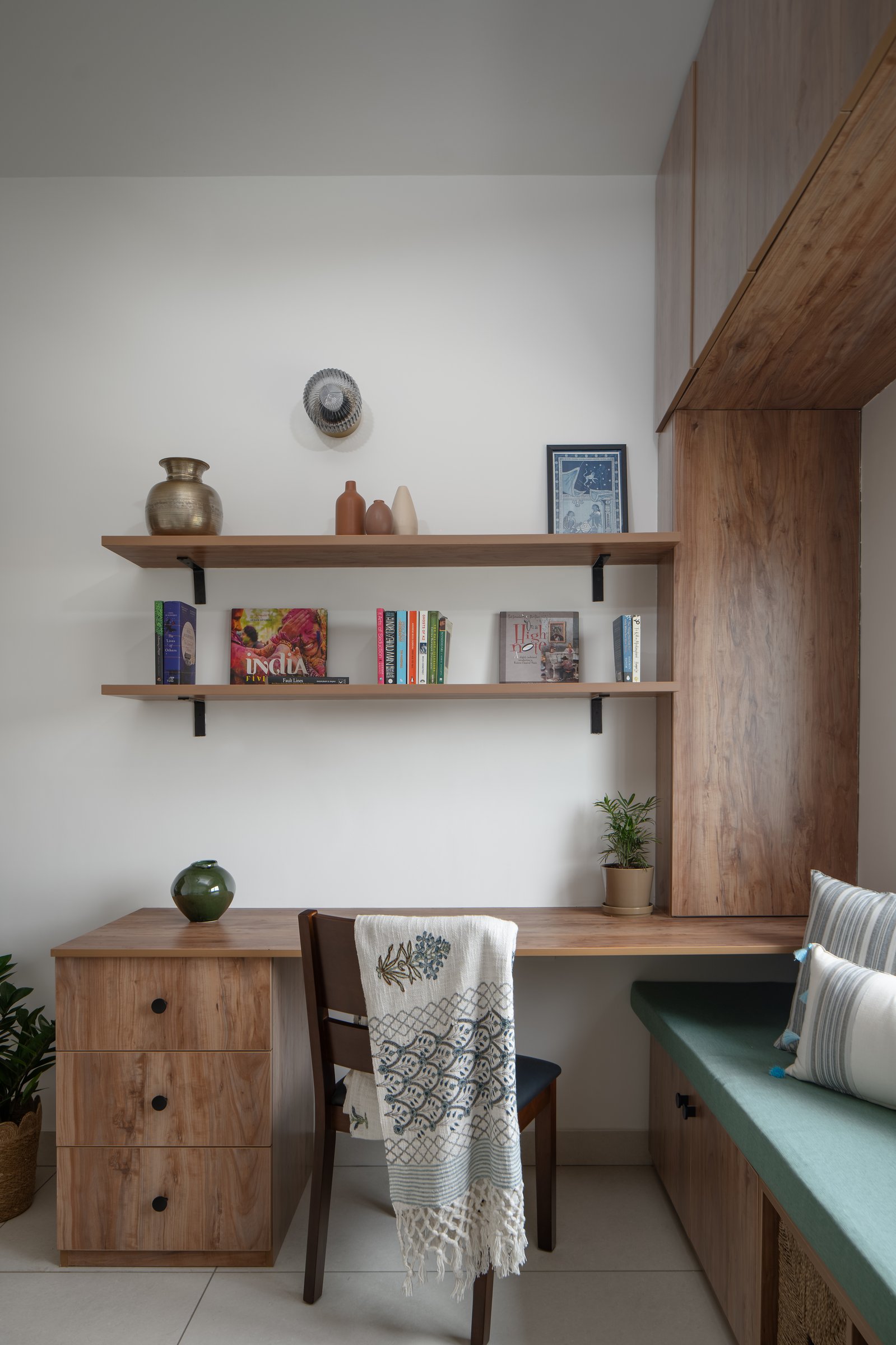 The study nook, where a built-in desk and shelves in blond hardwood belong to the home rather than an office