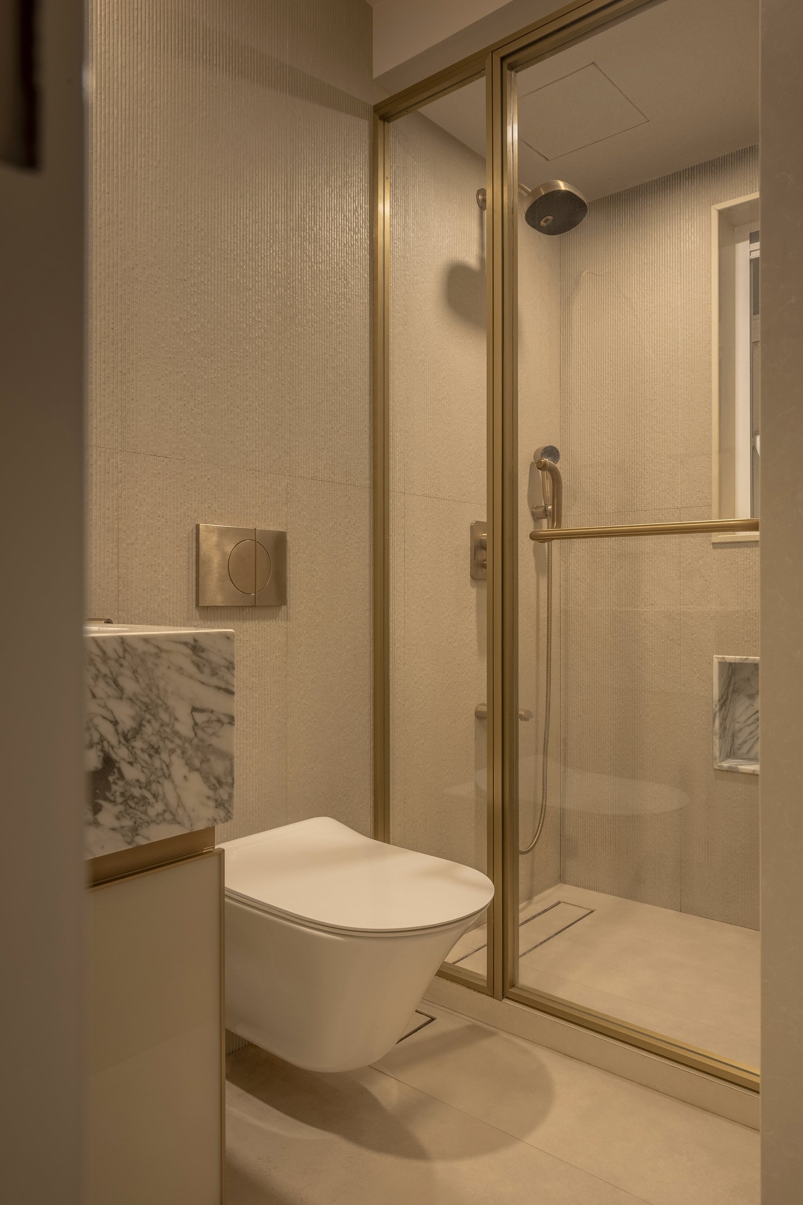 The shower area continues the home's material grammar into its most functional room