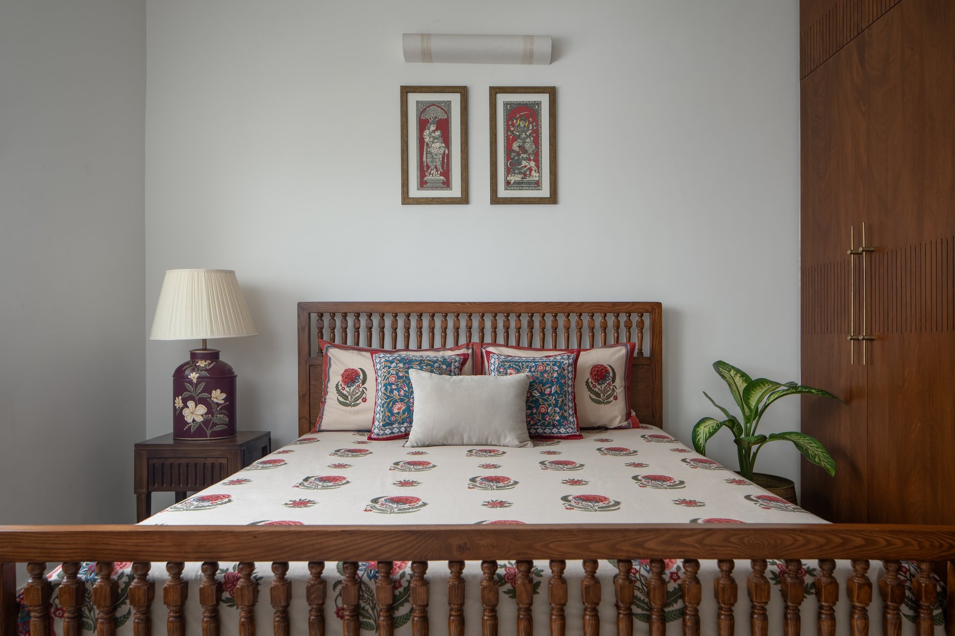 A second bedroom, where a spindle-backed bed and block-printed cushions extend the home's material language