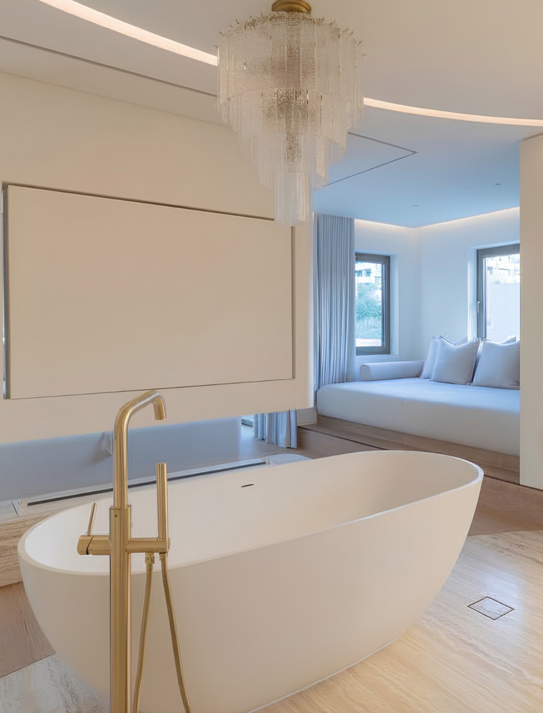 An oval freestanding tub anchors the principal bathroom beneath a tiered glass chandelier.