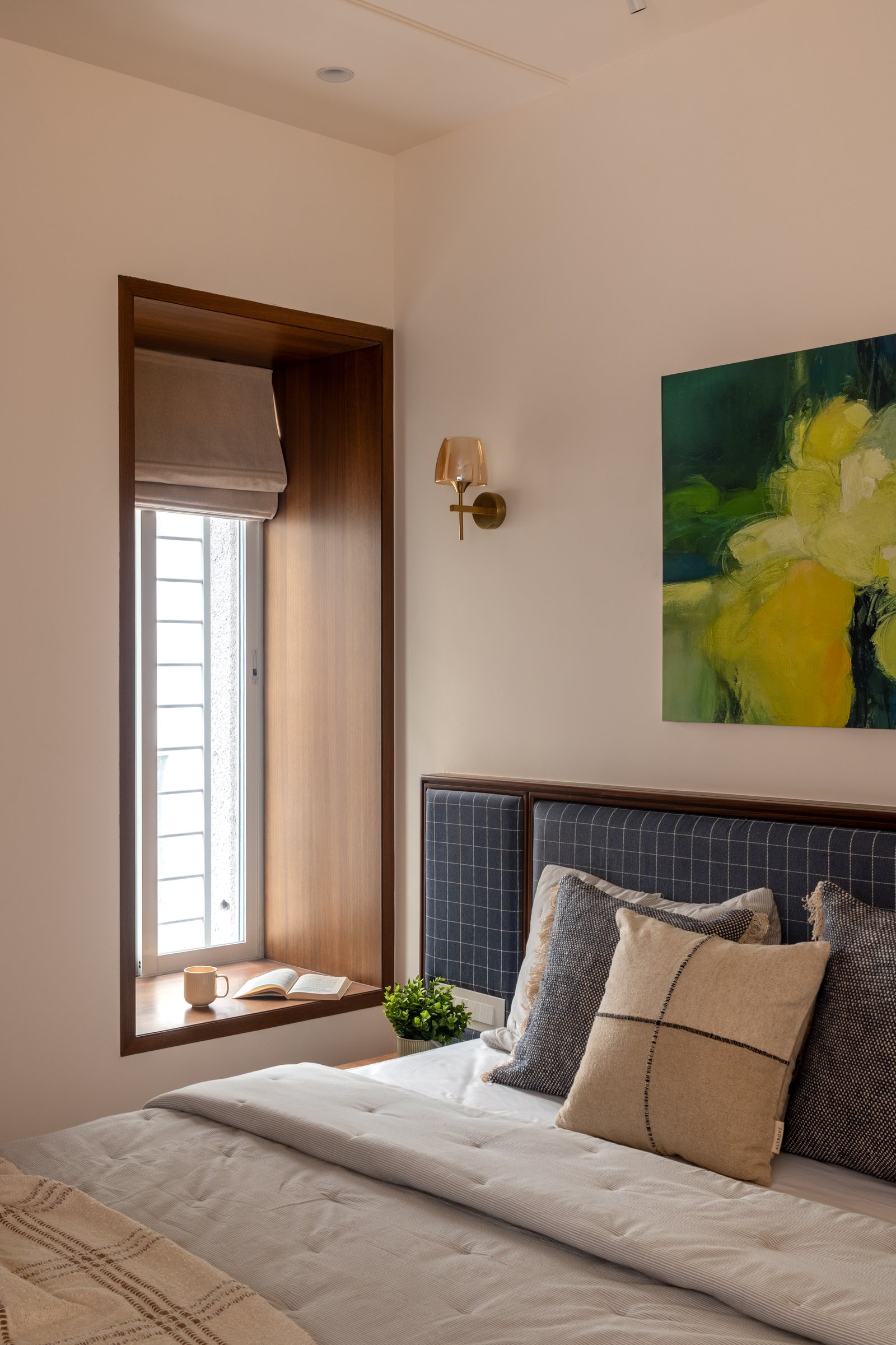 A slim window framed as a deep timber-lined recess in the second bedroom