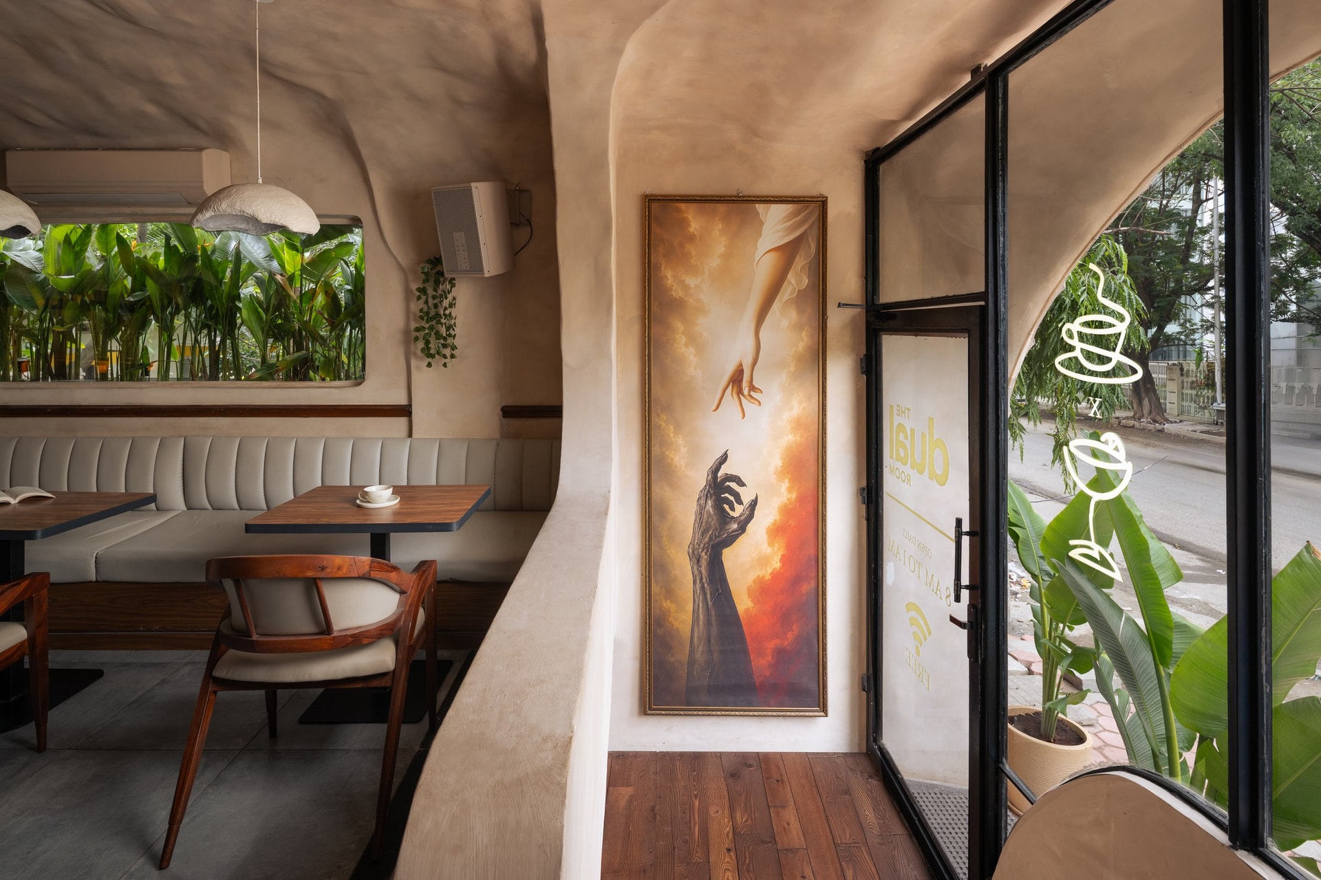 The entry threshold, anchored by a framed artwork of two reaching hands beside the glazed door