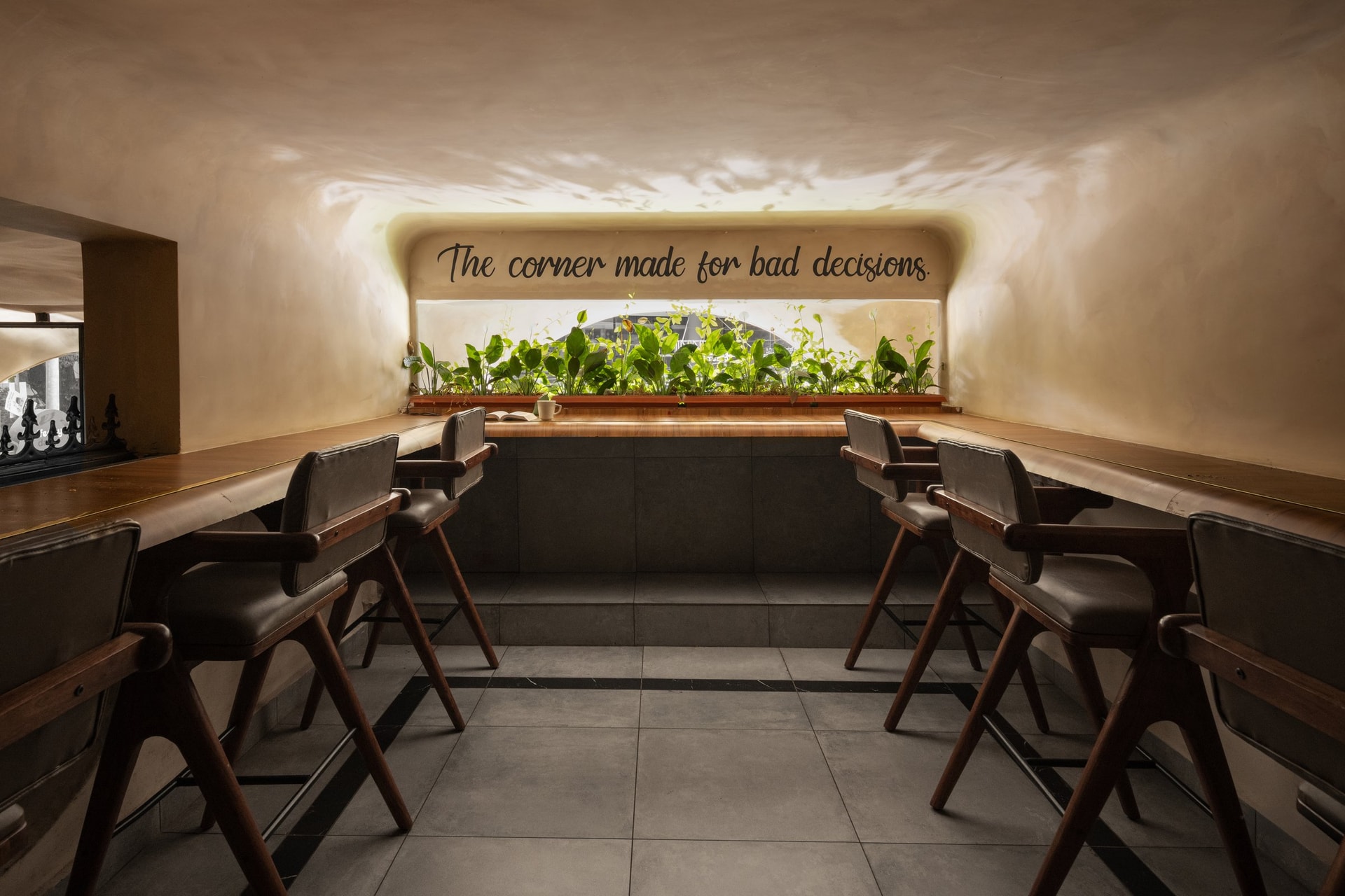 The work corner, capped by a planted trough and a hand-lettered line above the counter