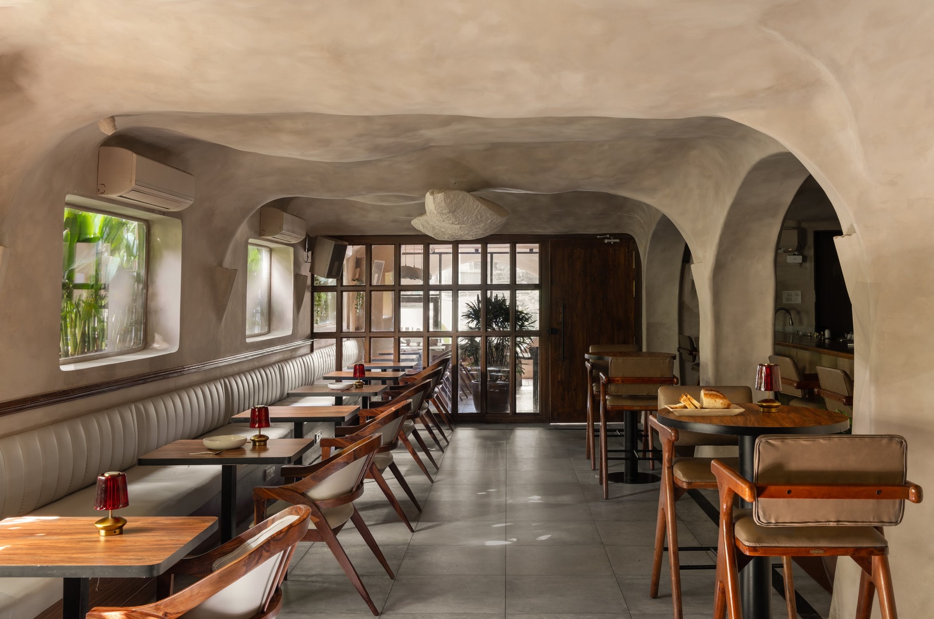 The room by day, its arched openings stepping through the plan in a slow rhythmic sequence