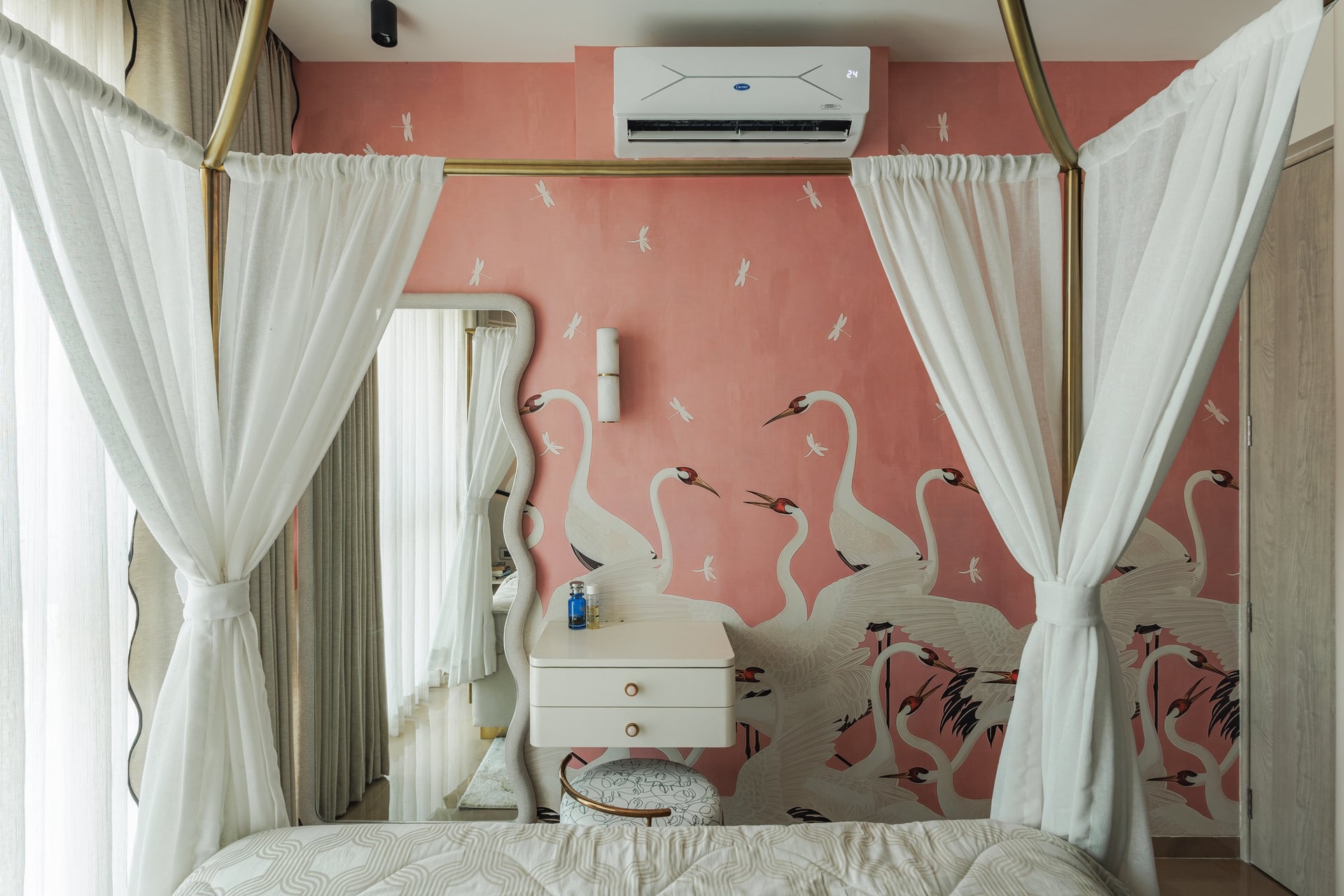The daughter's bedroom, where a hand-detailed crane and dragonfly wallpaper frames a brass four-poster bed