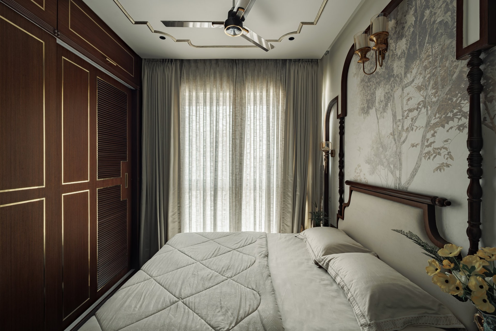 The wider master bedroom, revealing tall walnut wardrobes with brass inlay opposite the arched headboard