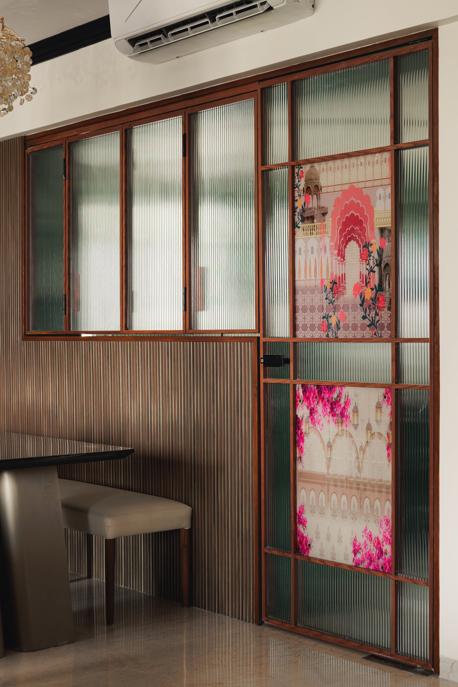 A second fluted glass panel with a printed architectural motif functions as both divider and composed ornament