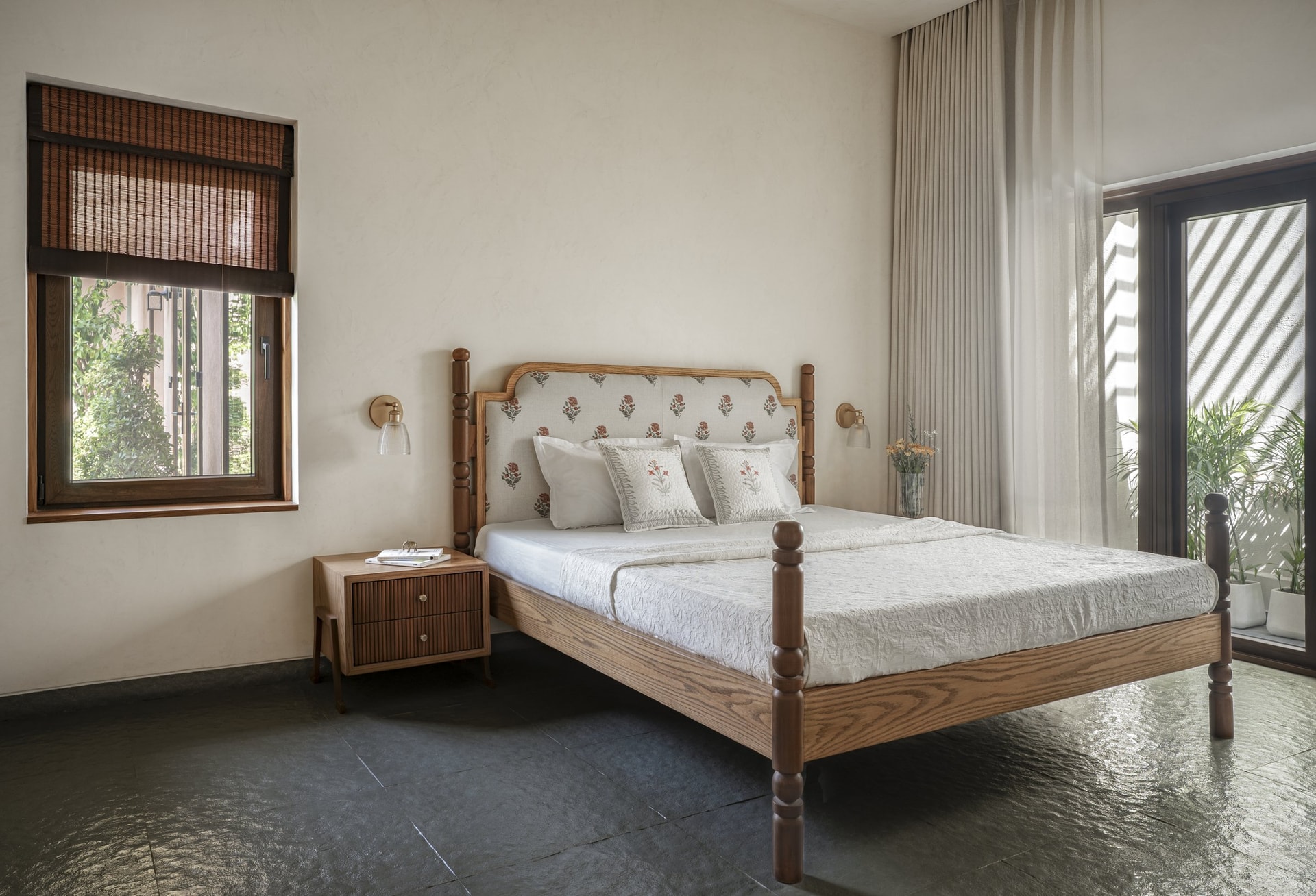 The primary bedroom, its bed built from timber repurposed from the original home