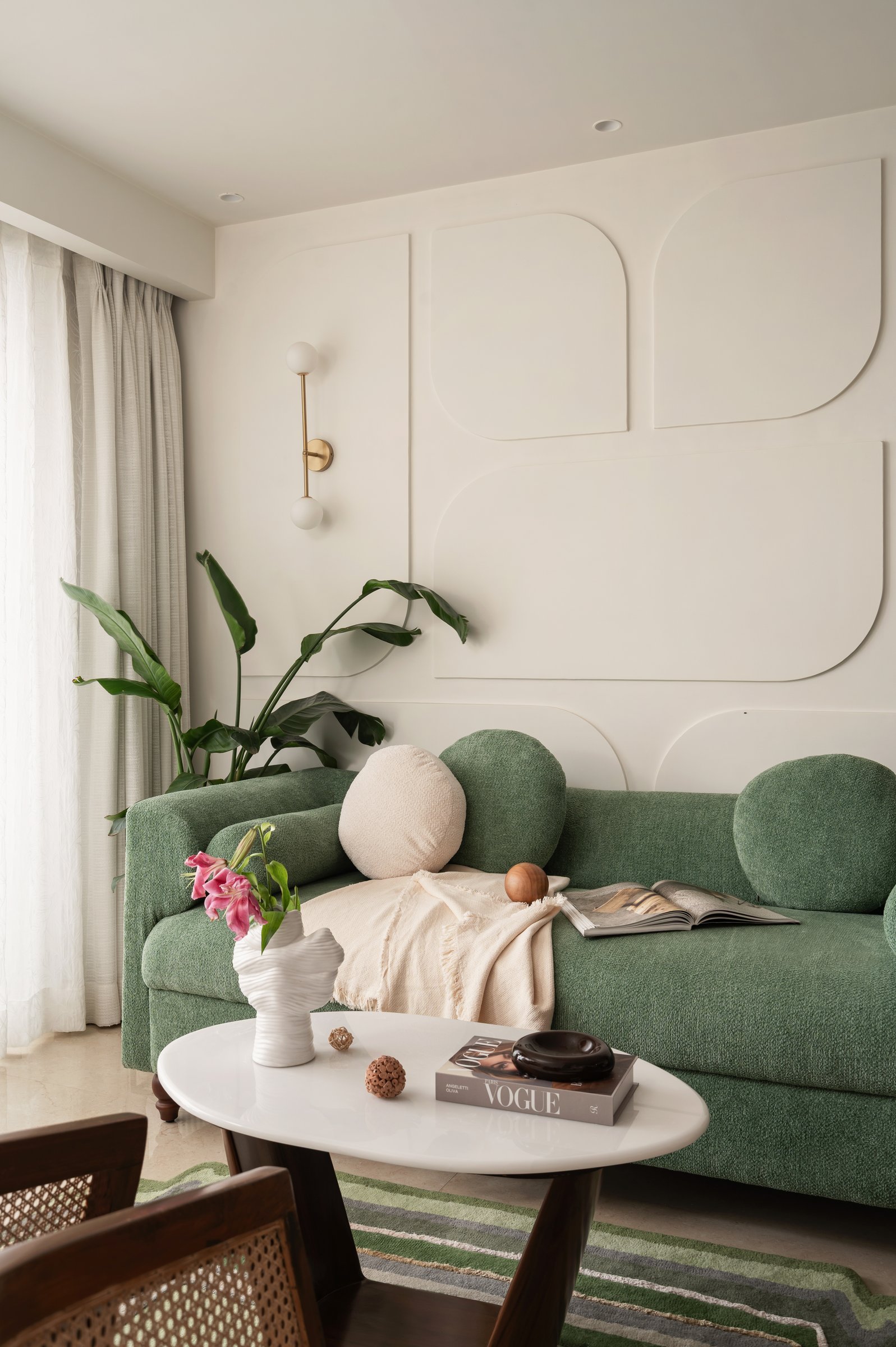 A second view of the living room, organised around conversation rather than a television wall