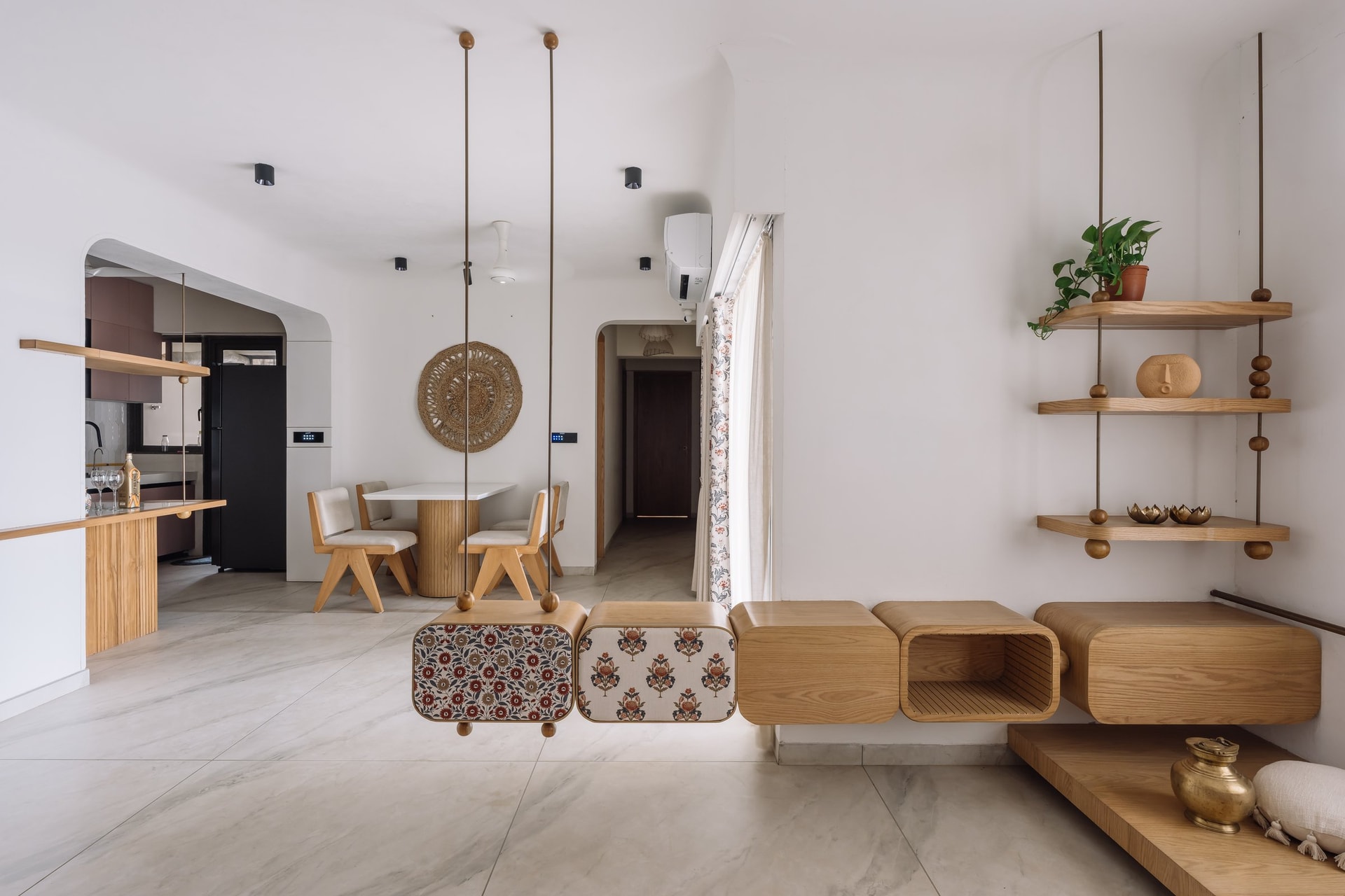 The suspended composition seen from the dining side, where it acts as a visual threshold between the living area and the dining zone beyond