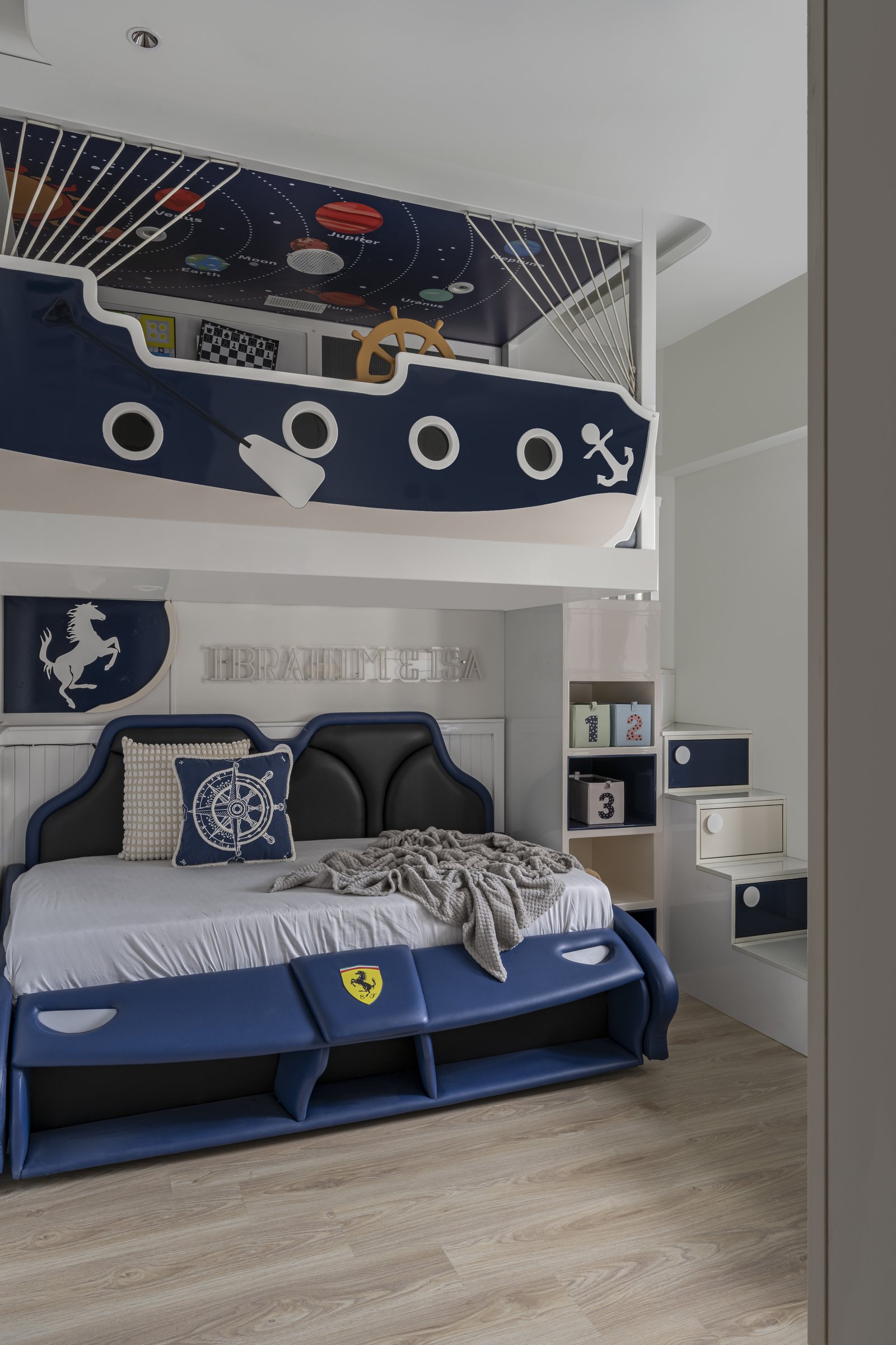 The children's bedroom, with a nautical-themed bunk composition shaped as a ship's prow above a padded lower bed