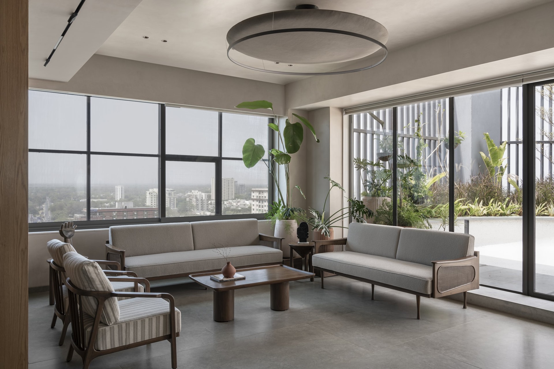 A second lounge arrangement, where an arched wooden display unit anchors a quieter corner