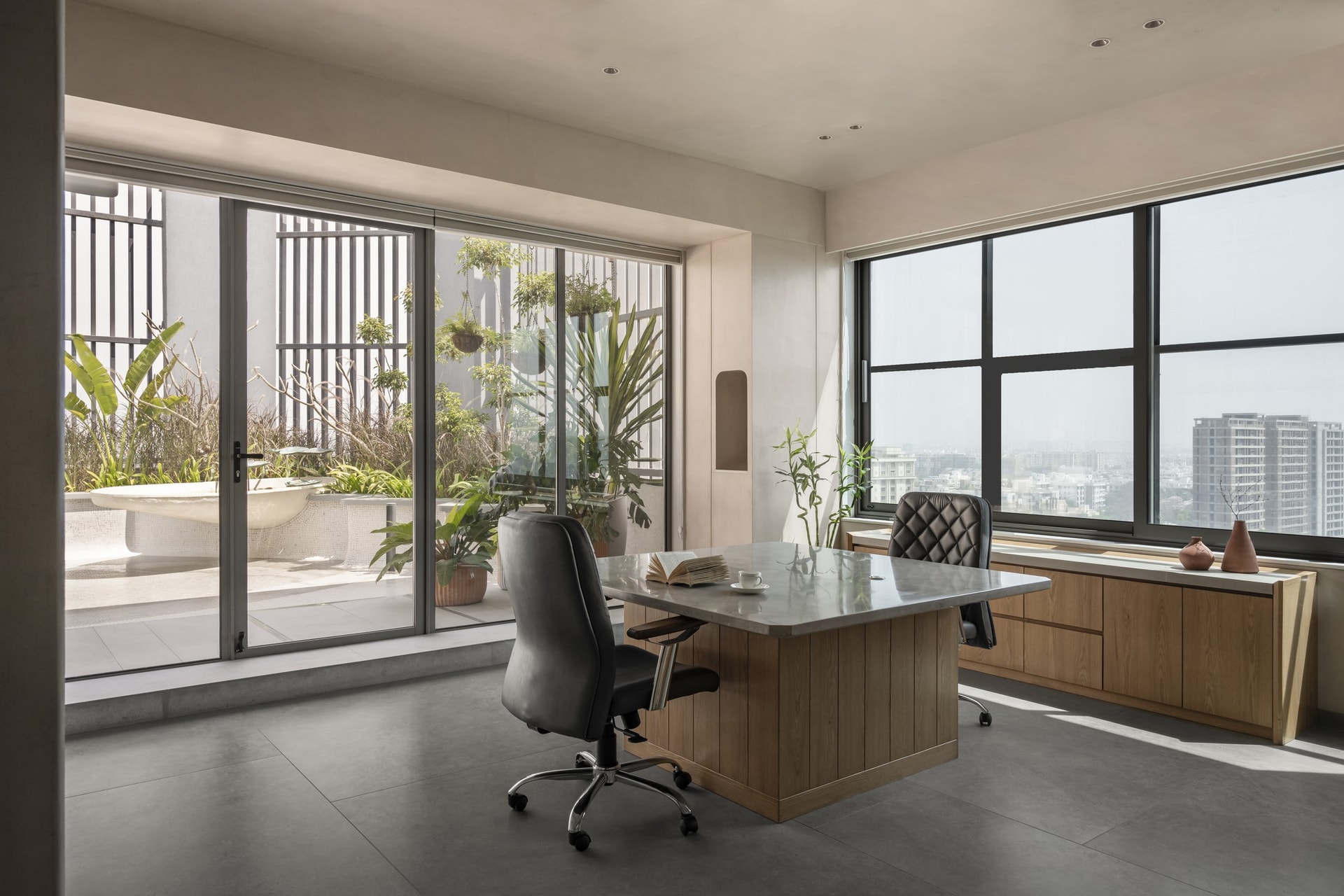 The cabin's working zone, where sliding glass doors open onto the terrace balcony beyond