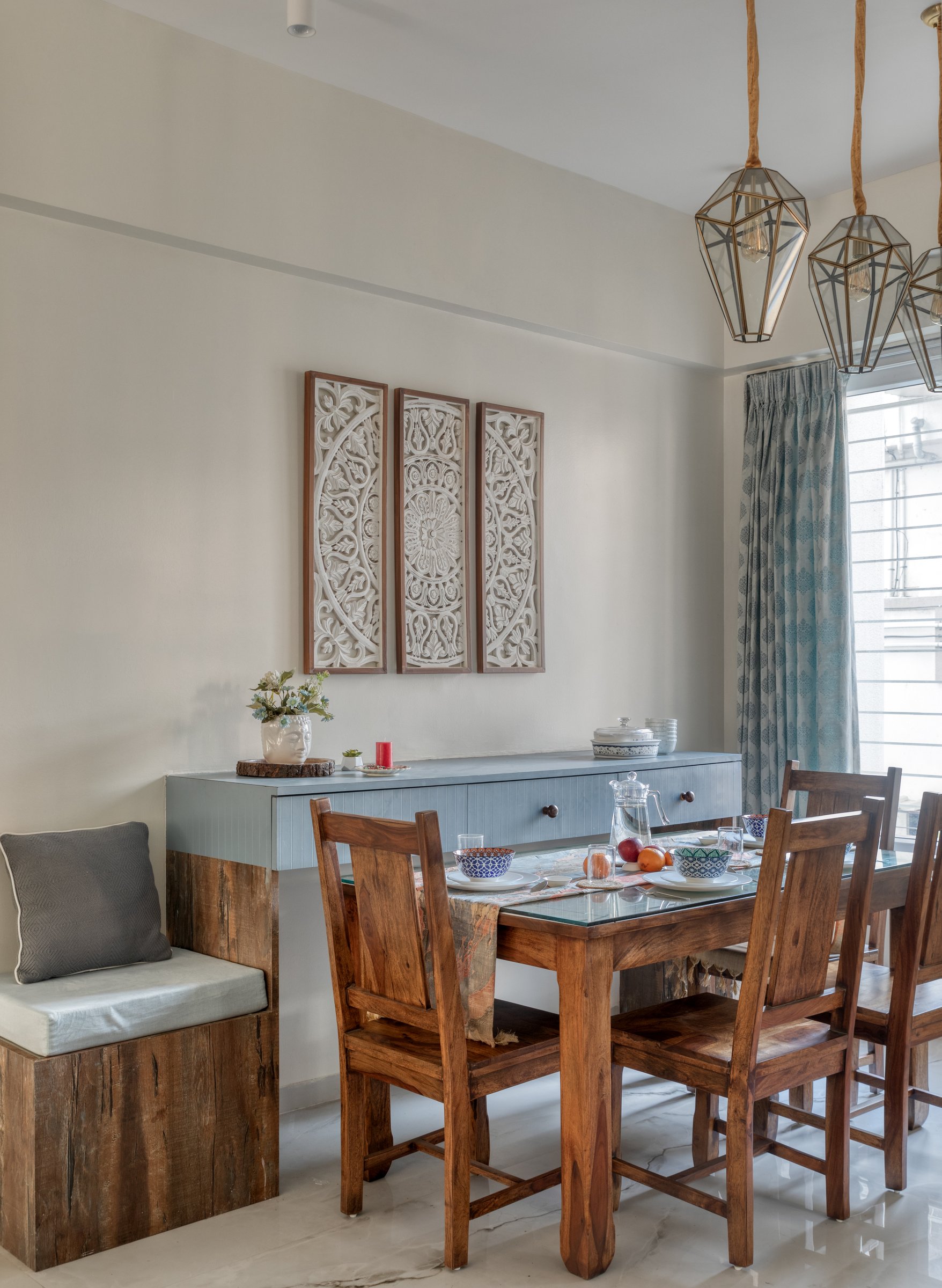 The dining table: solid sheesham, carved triptych panels, and a rustic bench seat that grounds the arrangement