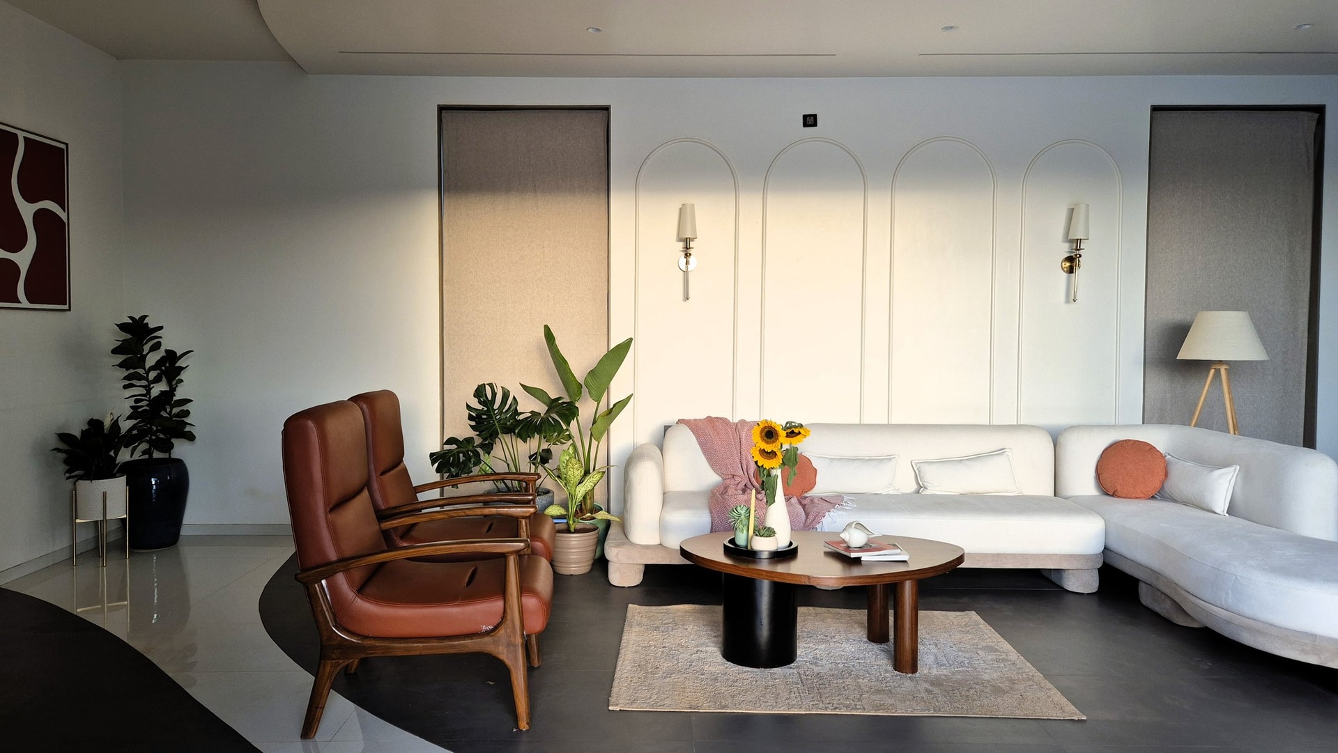 The living room from the sofa wall, where arched panelling and a restrained palette let the Sahyadri do the talking
