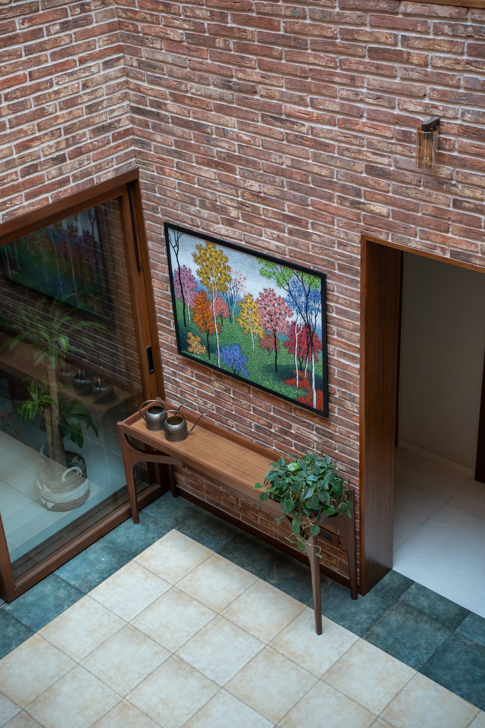 The entry volume seen from above, where the double-height brick atrium first reveals its vertical ambition