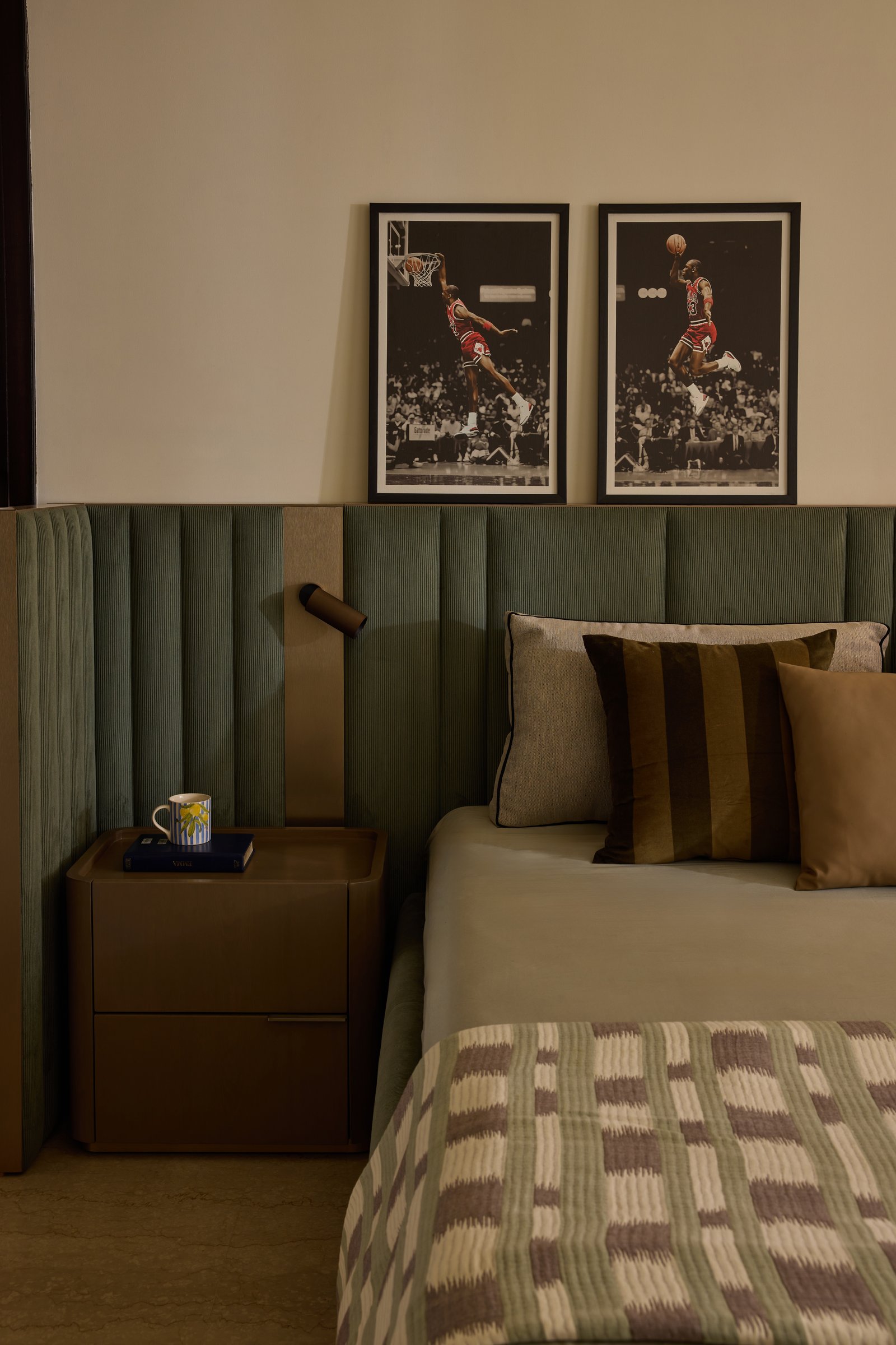 A detail of the headboard, its ribbed velvet integrating a cantilevered reading light against a tan leather panel