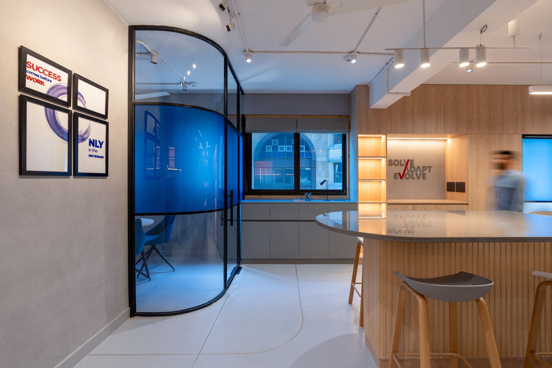 The curved blue-tinted glass pod, where colour becomes transparency rather than surface