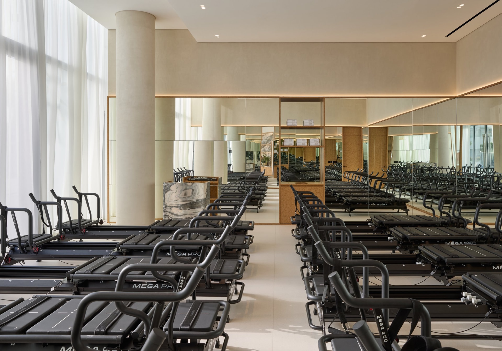 Seen from the opposite end, the custom ribbed marble DJ booth anchors the back of the room