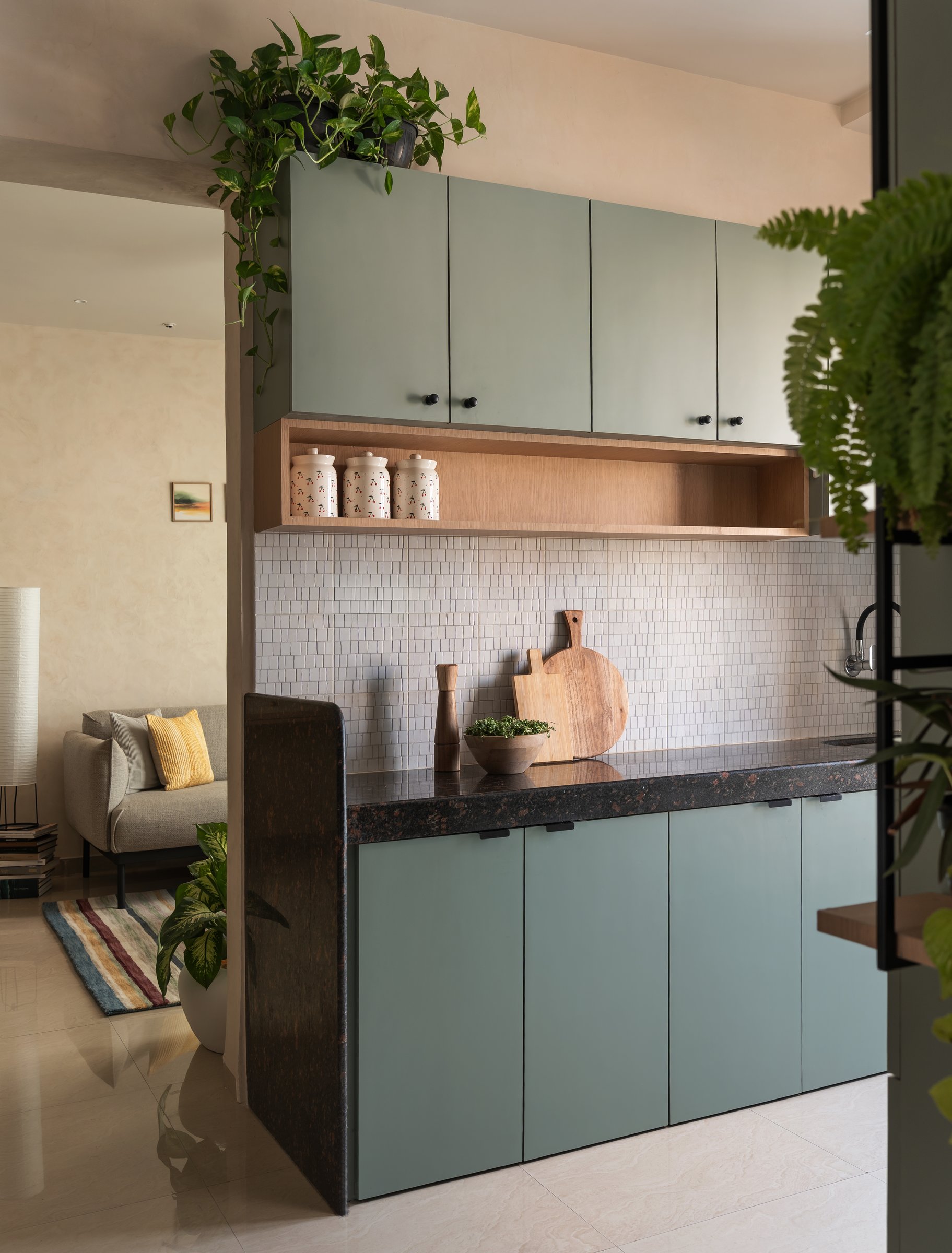 The kitchen, where a granite-topped half wall doubles as a service counter toward the living room