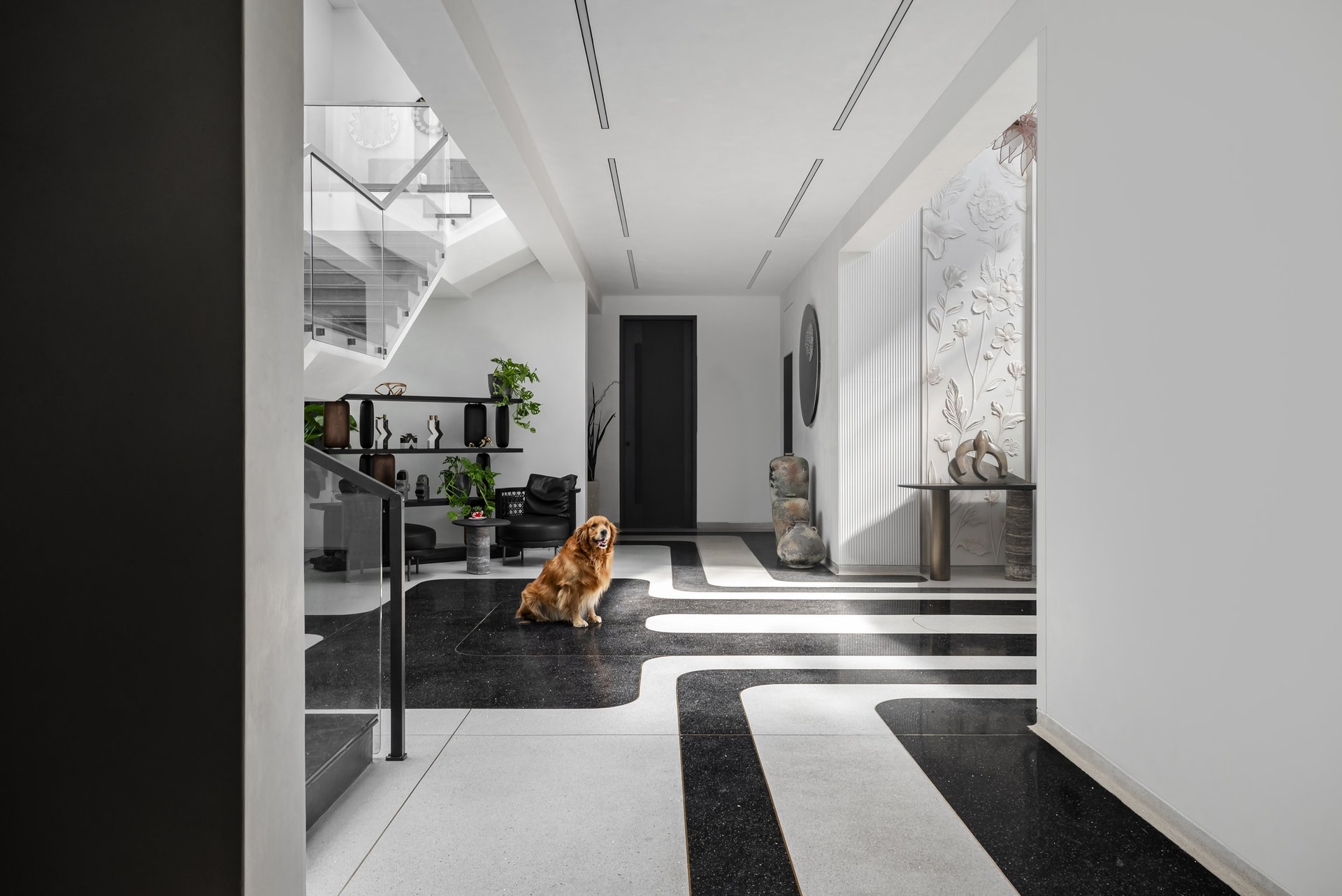 Looking into the foyer from the entry: the curving stone inlay choreographs the path forward