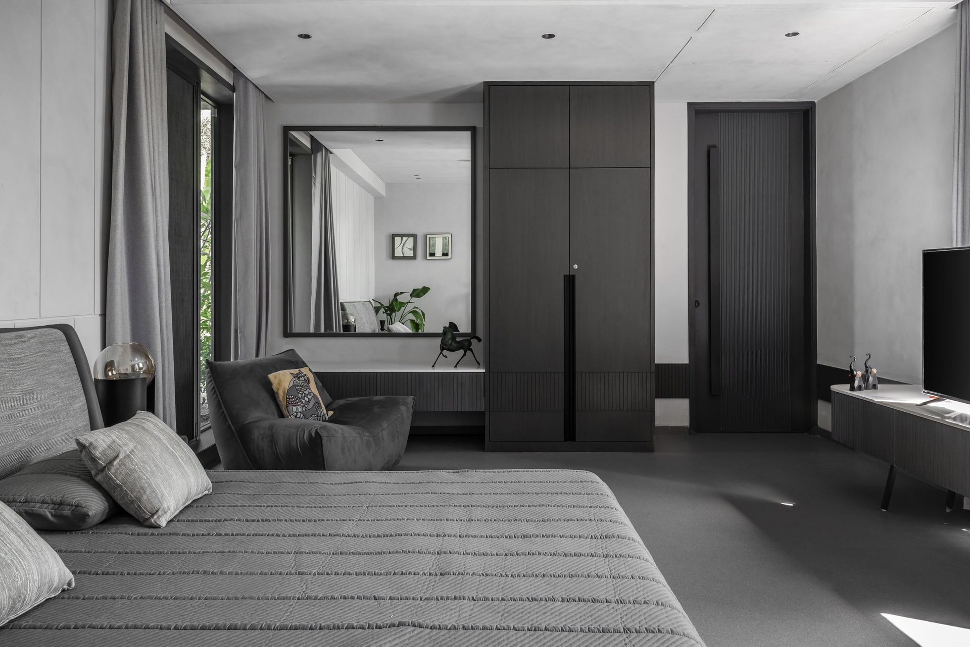 The master bedroom takes the palette into quieter, deeper territory