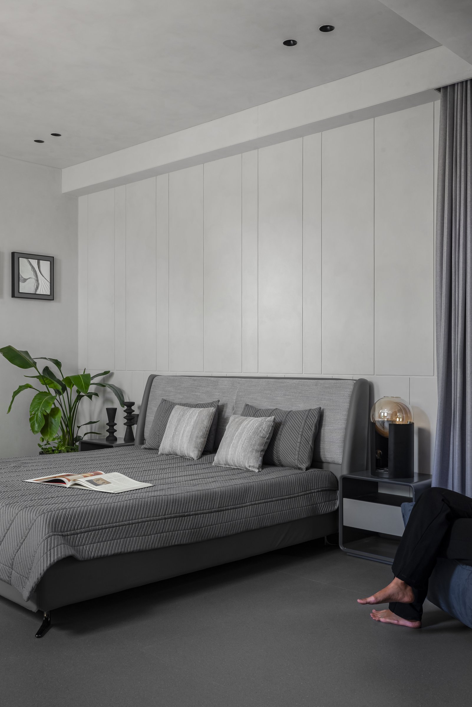 The second bedroom: a panelled feature wall in pale plaster carries the rhythm