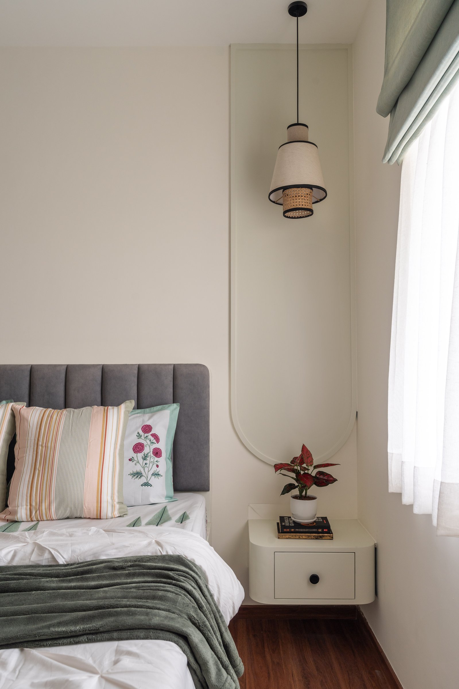 The guest bedroom keeps the home's coastal vocabulary but lowers its volume