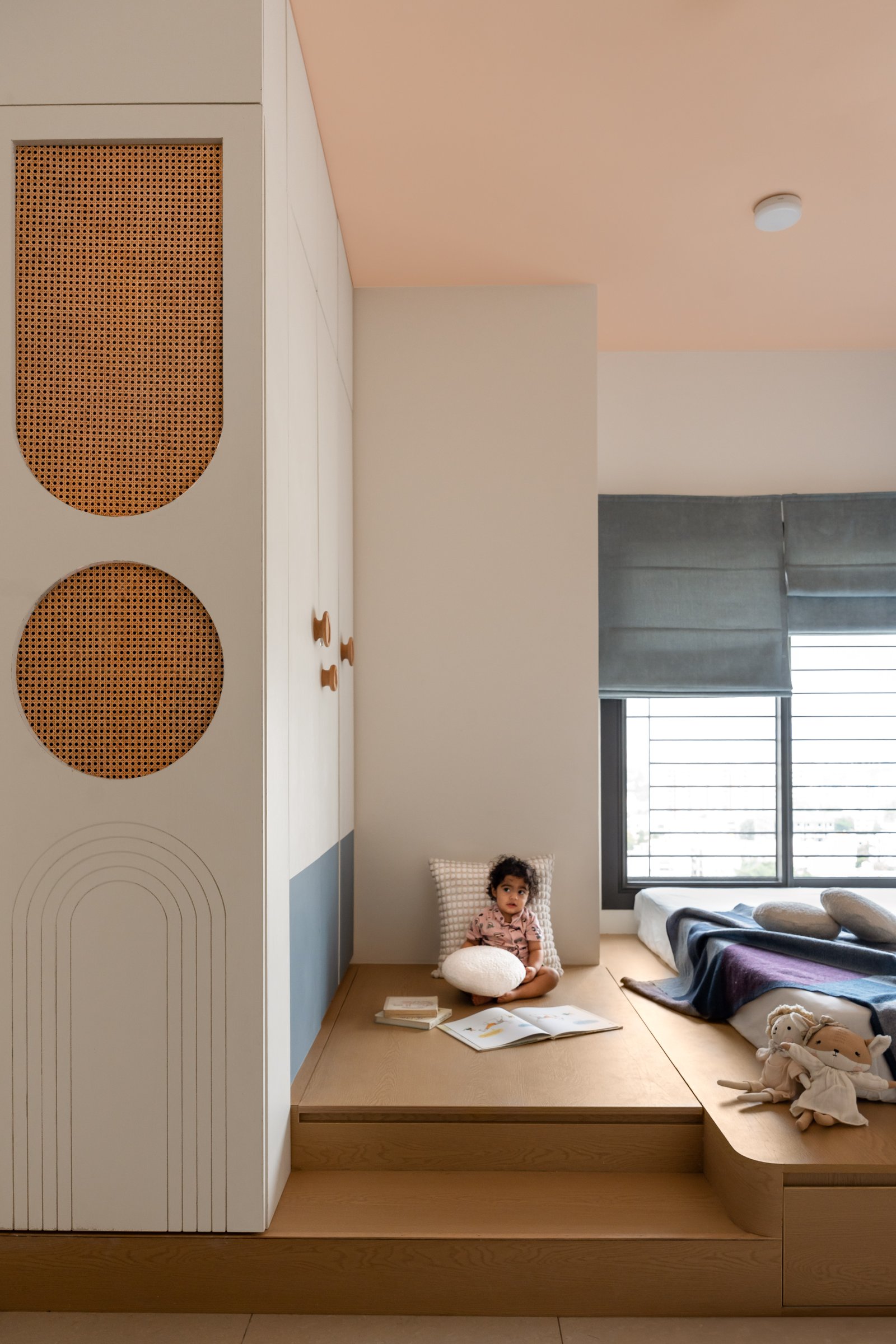 The wardrobe's wooden knobs scatter at child-height, scaled for curious fingers