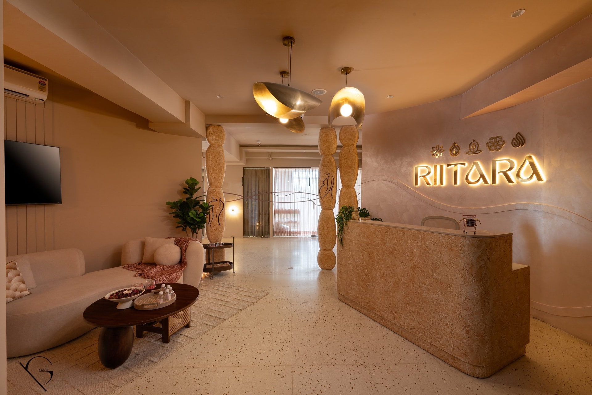 The reception, anchored by two hand-finished totems etched with the feminine form and a pair of scooped brass pendants
