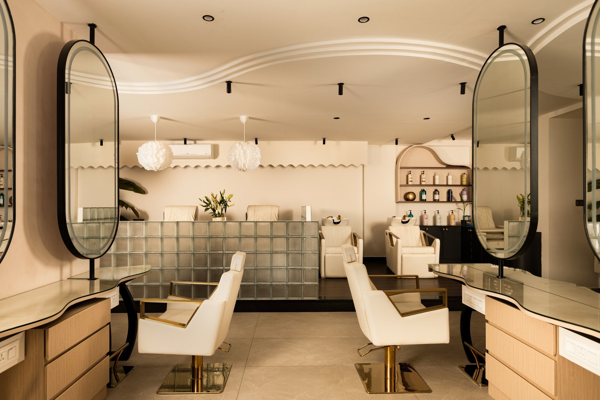 The styling floor, where a sculptural plaster ribbon across the ceiling mirrors a scalloped pelmet behind