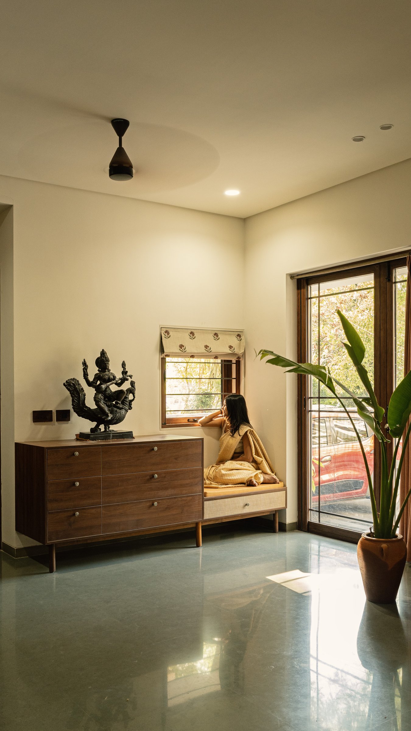 Seen from another angle, the foyer reads as a composed room: terracotta, polished floor, framed light