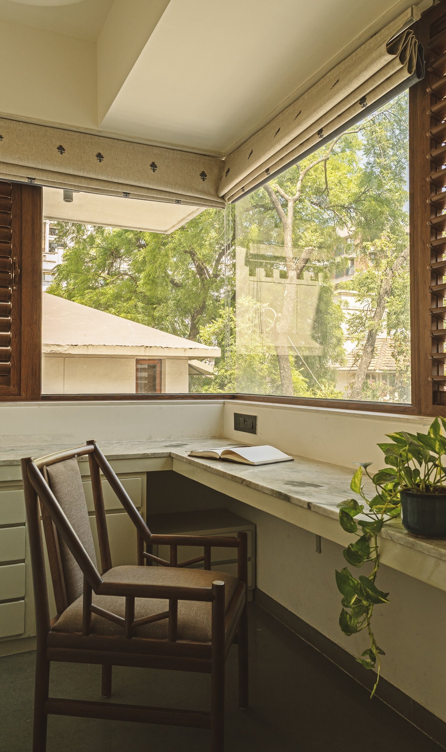 A built-in window-bay work nook offering its occupant a flat surface, good light, and a view