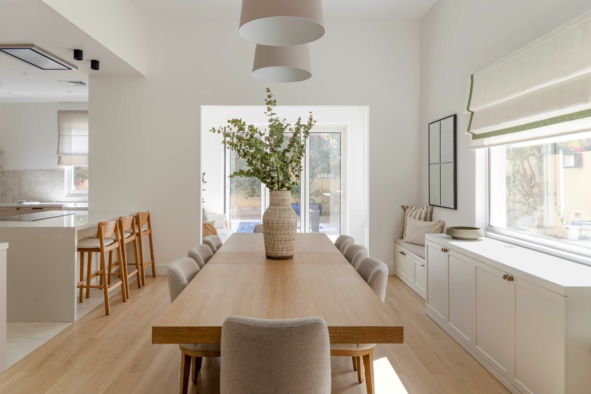 The dining room opens directly onto the kitchen and the garden beyond, refusing formality without losing gravity