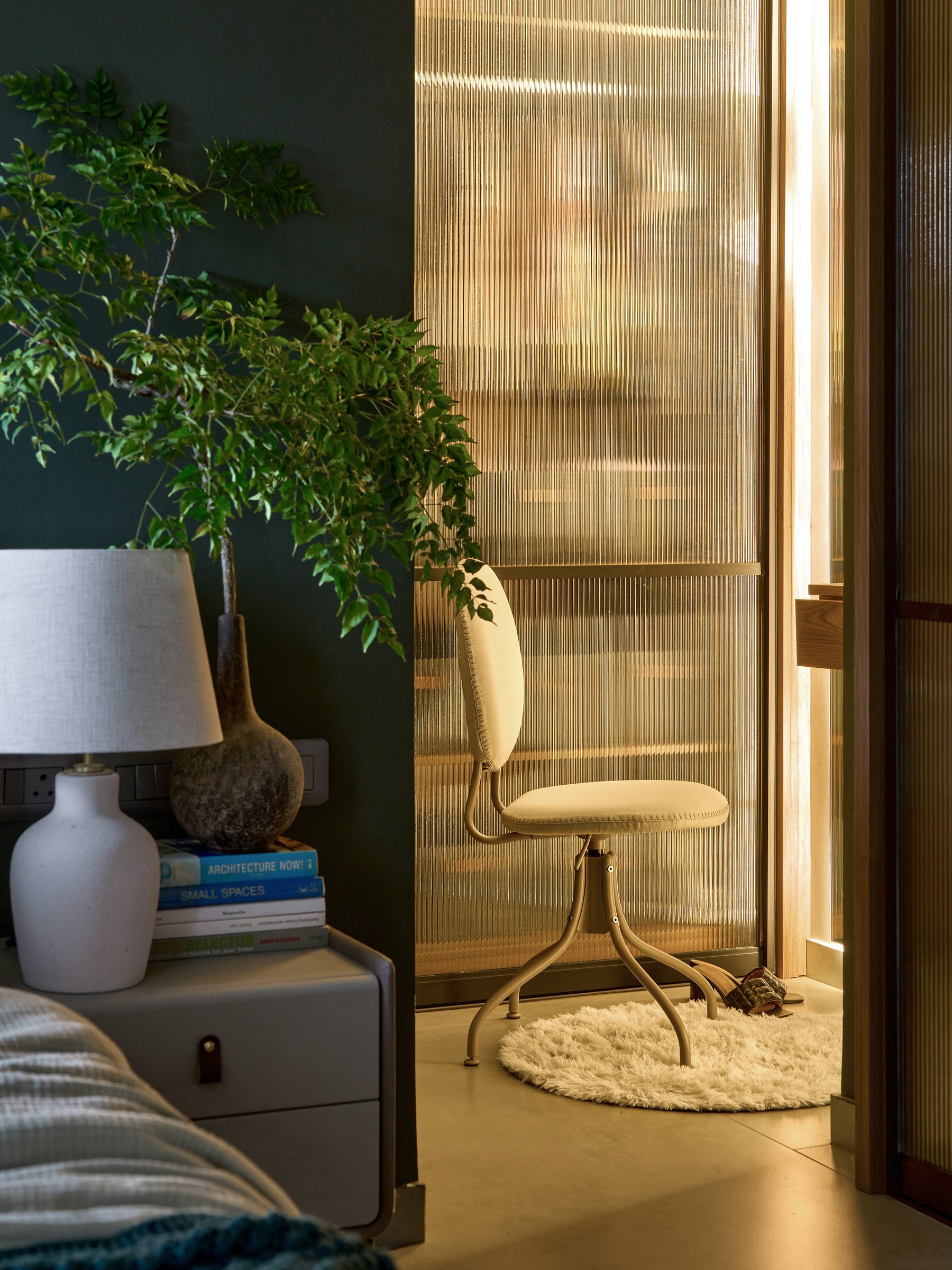 The writing nook behind the reeded glass partition, where filtered light turns the screen into a glowing plane