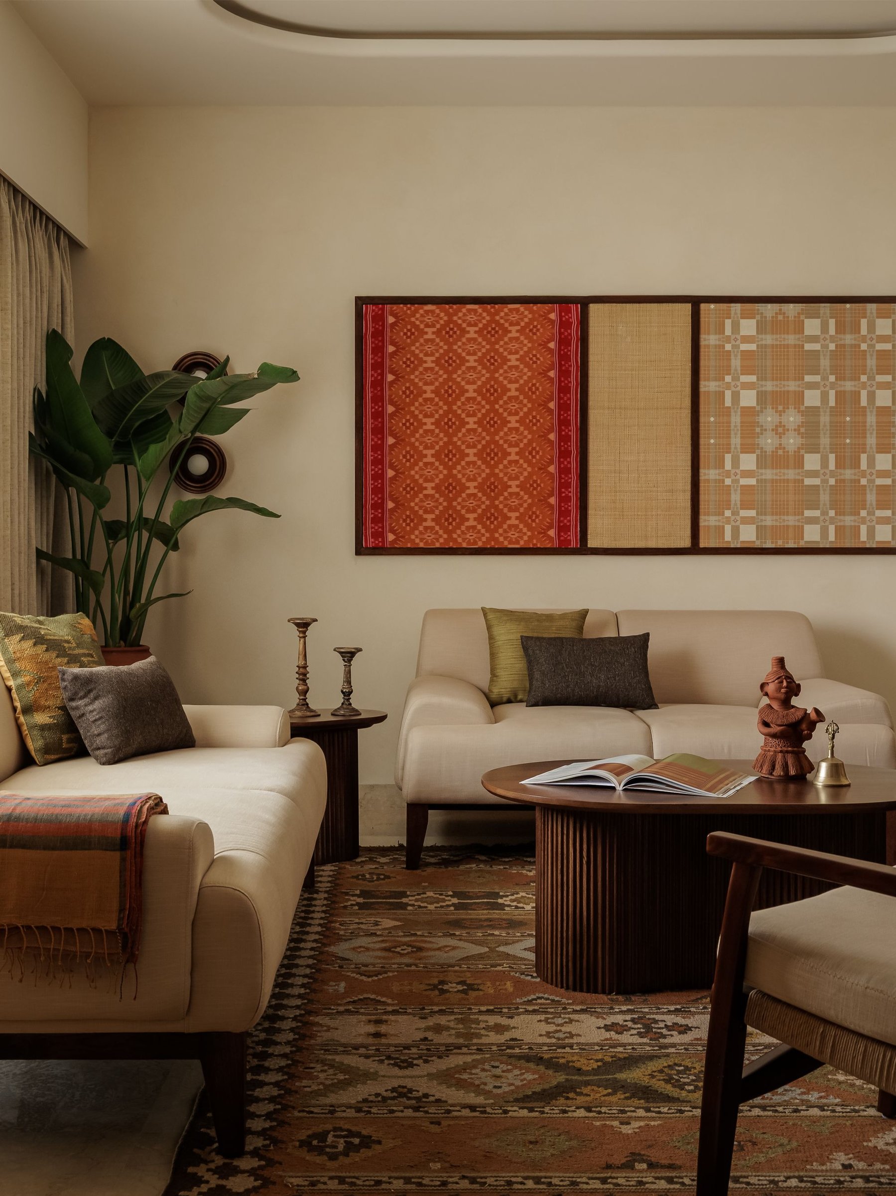The triptych above the sofa, textile elevated to the status of painting