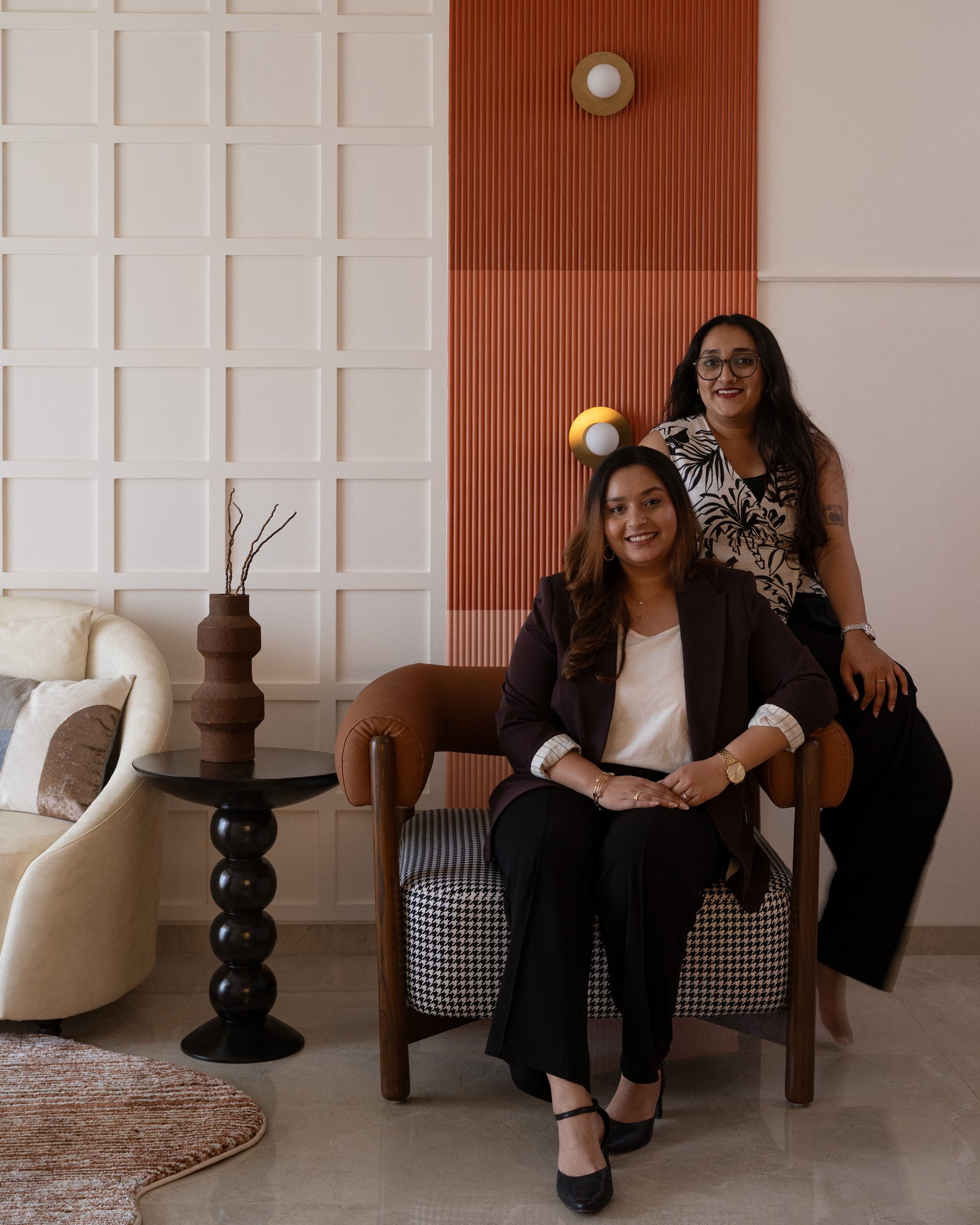 Ar. Vaijayanti Khade and Ar. Isha Parmar of V' Atelier, photographed against the home's signature terracotta panel