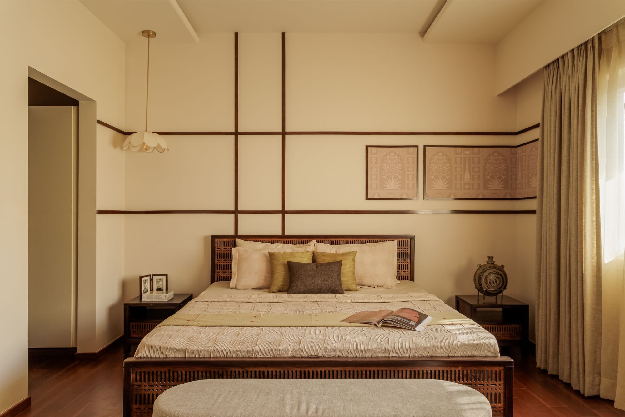 The second bedroom, where dark wooden strips form a contemporary geometric grid above a cane-headboard bed