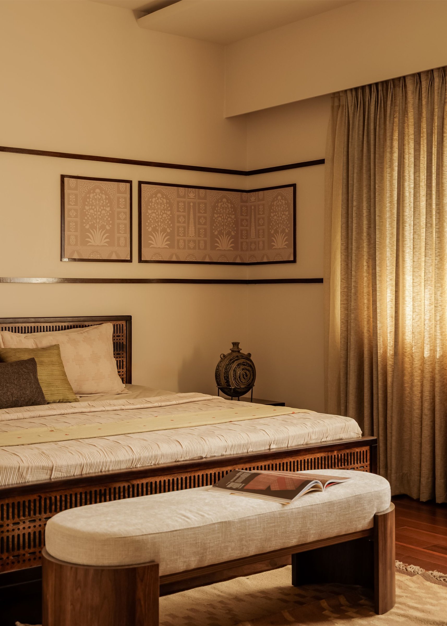 Mughal-inspired panels in soft blush hold the room's calm centre