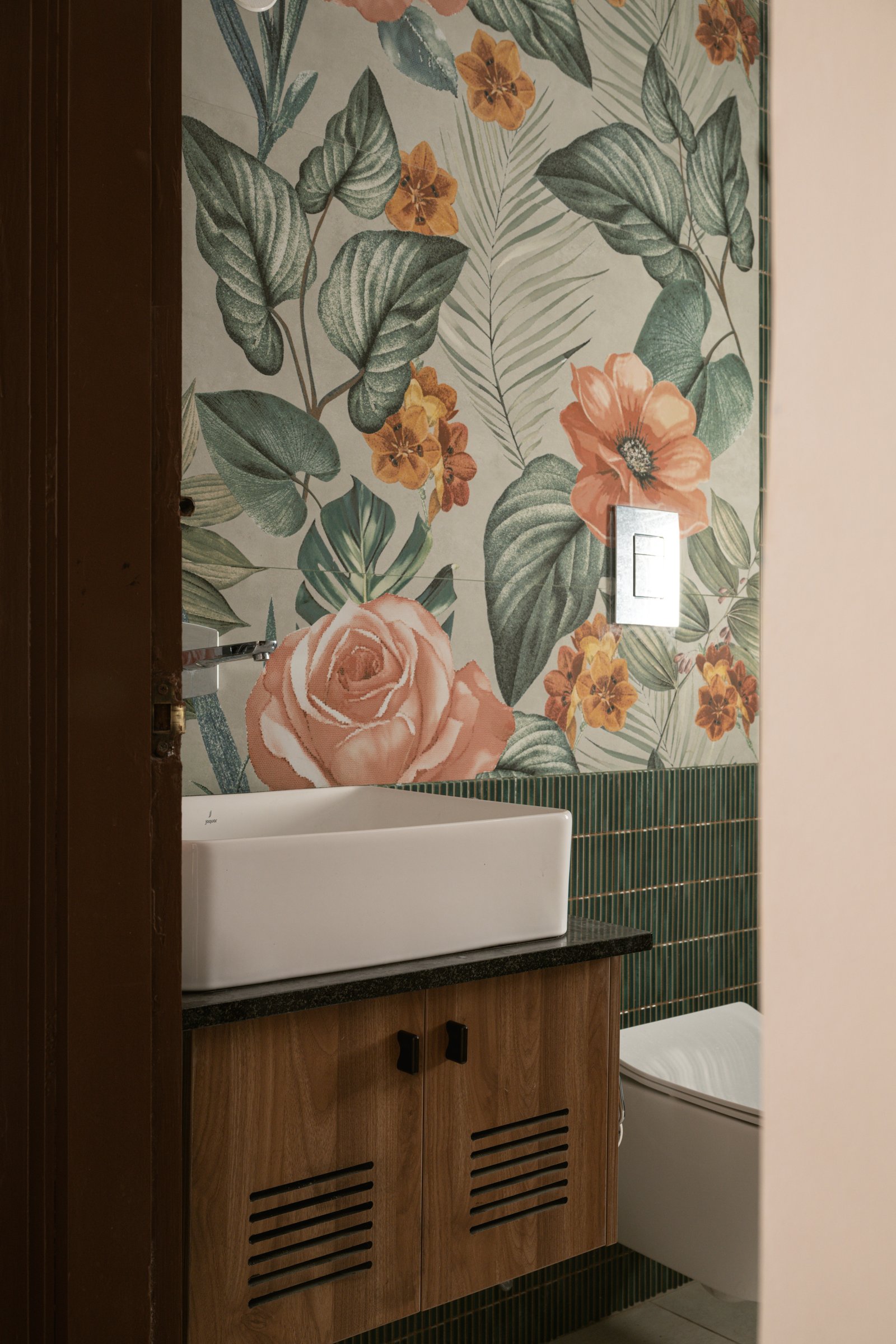 The second bathroom's tropical-foliage mural tile, the one room in the home where colour is fully let off the leash