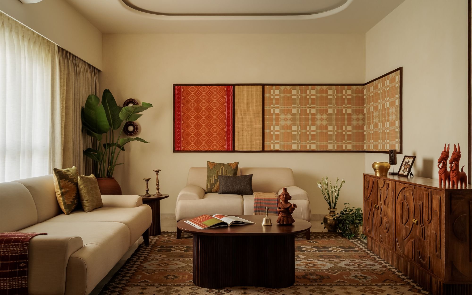 The living room, where cream linen seating and a fluted wooden coffee table hold a deliberate calm