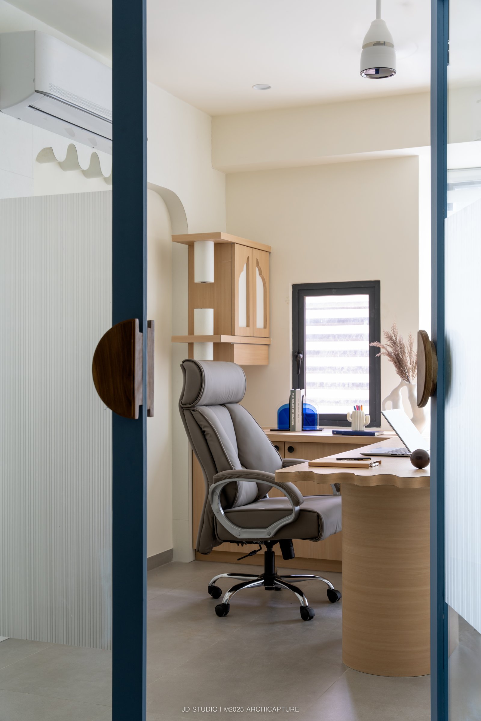 The working cabin, where the curve appears only at the desk edge and the cabinet fronts