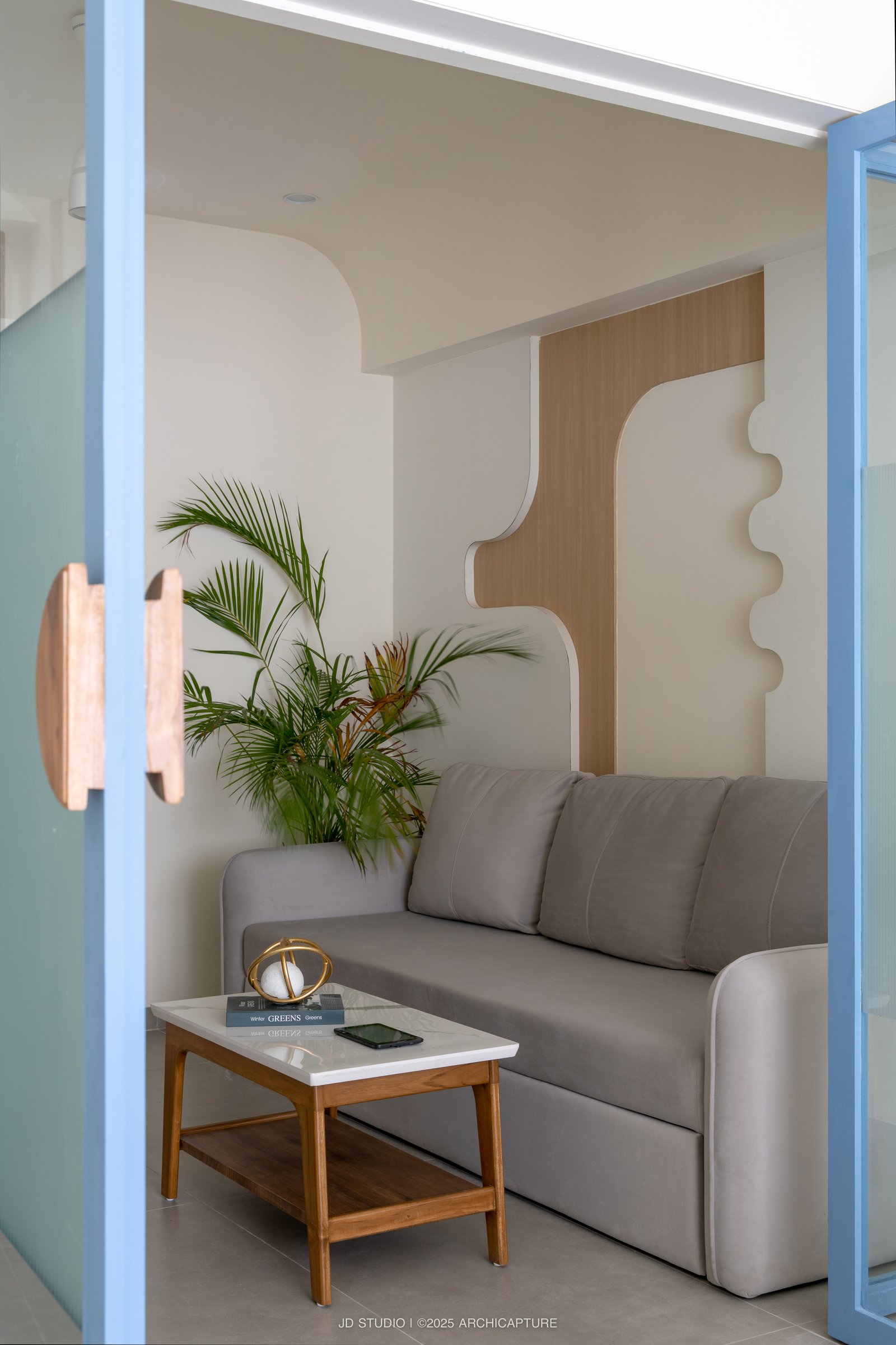 The partition threshold, with its wooden pull, framing the lounge as a small interior vignette