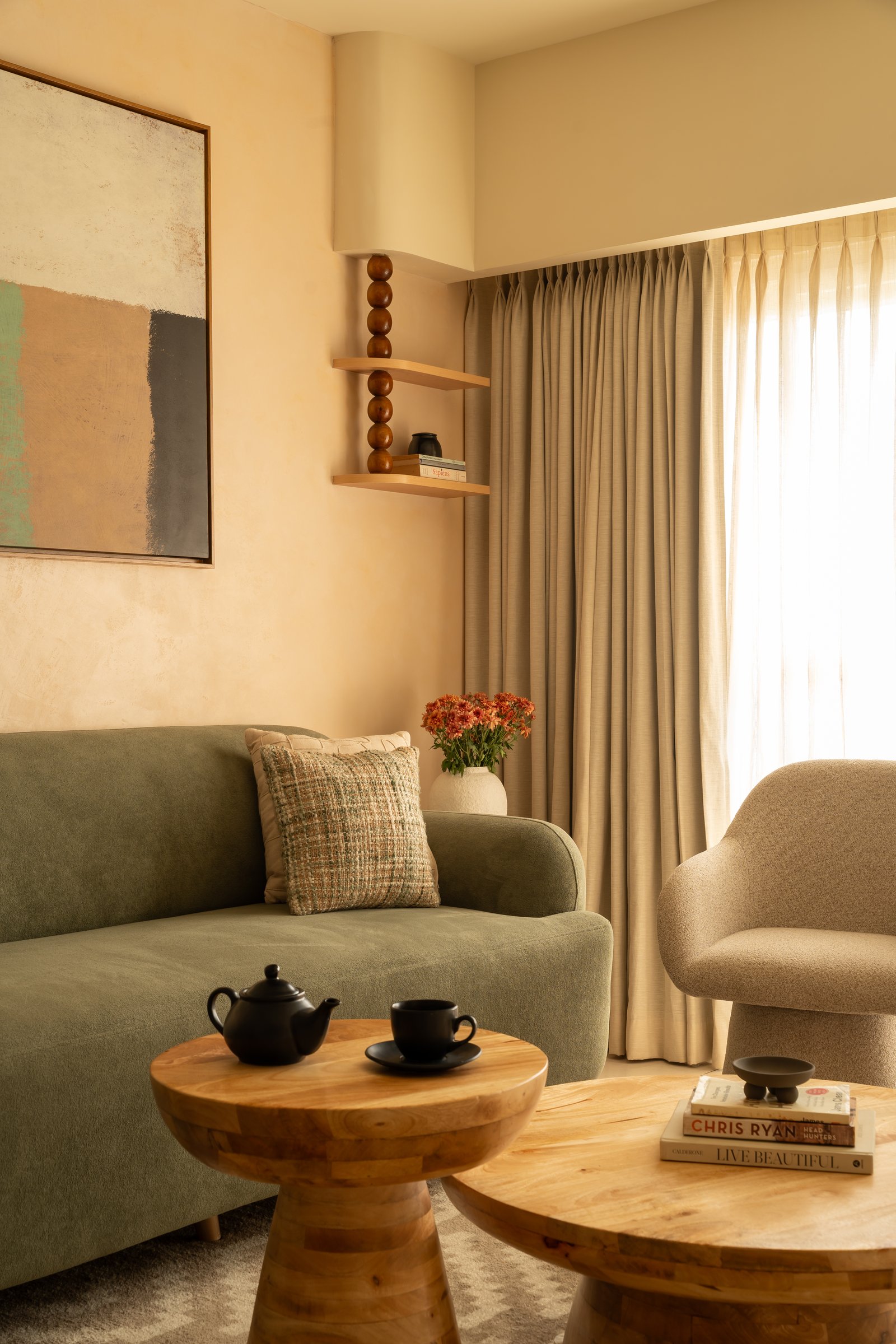 A corner of the living room, where curved silhouettes do the quiet work of softening the architectural lines